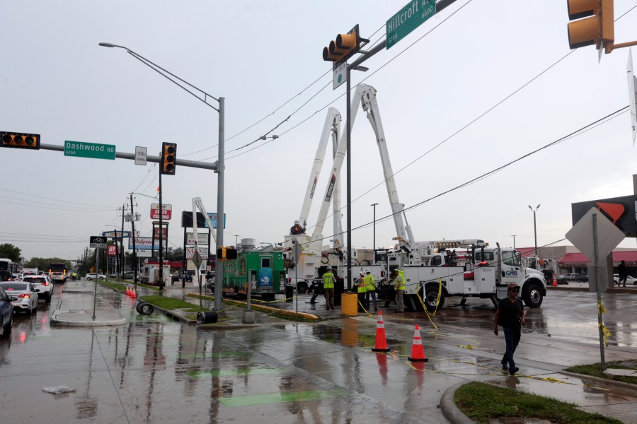 Utility crews work to restore electricity in Houston, Thursday, July 11, 2024. Officials say about 500,000 customers still won't have electricity into next week as wide outages from Hurricane Beryl persist. (AP Photo/Lekan Oyekanmi)