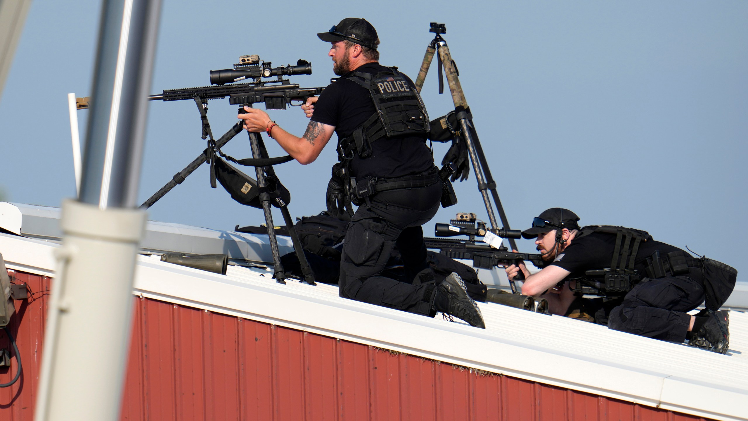 Police snipers return fire after shots were fired while Republican presidential candidate former President Donald Trump was speaking at a campaign event in Butler, Pa., on Saturday, July 13, 2024. (AP Photo/Gene J. Puskar)