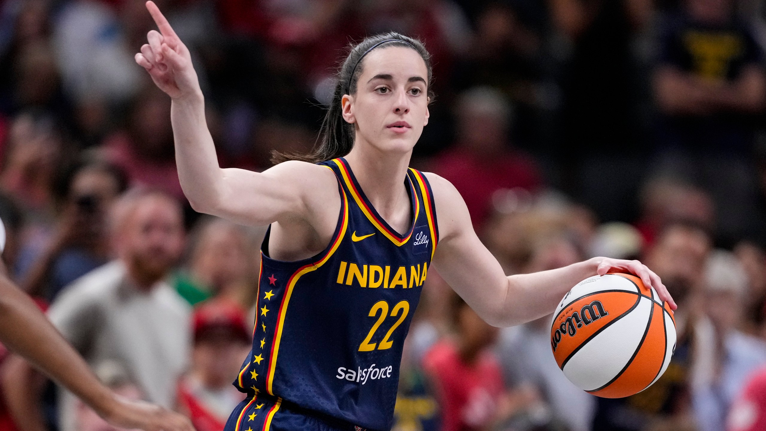 FILE - Indiana Fever guard Caitlin Clark (22) play sagainst the Washington Mystics in the first half of a WNBA basketball game in Indianapolis, Wednesday, July 10, 2024. Caitlin Clark and Angel Reese will once again step into the spotlight during All-Star Weekend with their matchup against Team USA. (AP Photo/Michael Conroy, File)