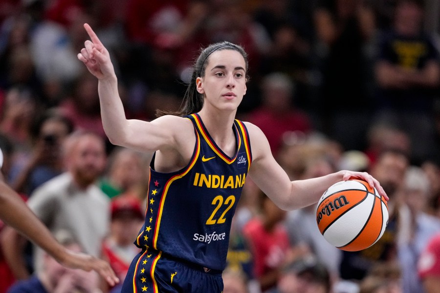 FILE - Indiana Fever guard Caitlin Clark (22) play sagainst the Washington Mystics in the first half of a WNBA basketball game in Indianapolis, Wednesday, July 10, 2024. Caitlin Clark and Angel Reese will once again step into the spotlight during All-Star Weekend with their matchup against Team USA. (AP Photo/Michael Conroy, File)