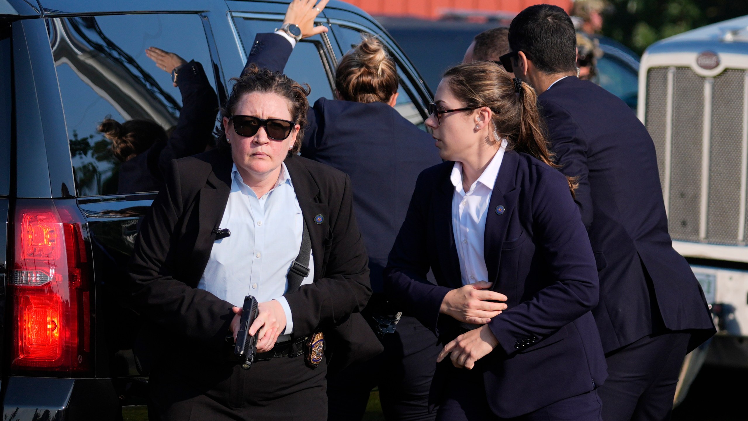 FILE - U.S. Secret Service agents surround the vehicle carrying Republican presidential candidate former President Donald Trump at a campaign rally, Saturday, July 13, 2024, in Butler, Pa. (AP Photo/Evan Vucci, File)