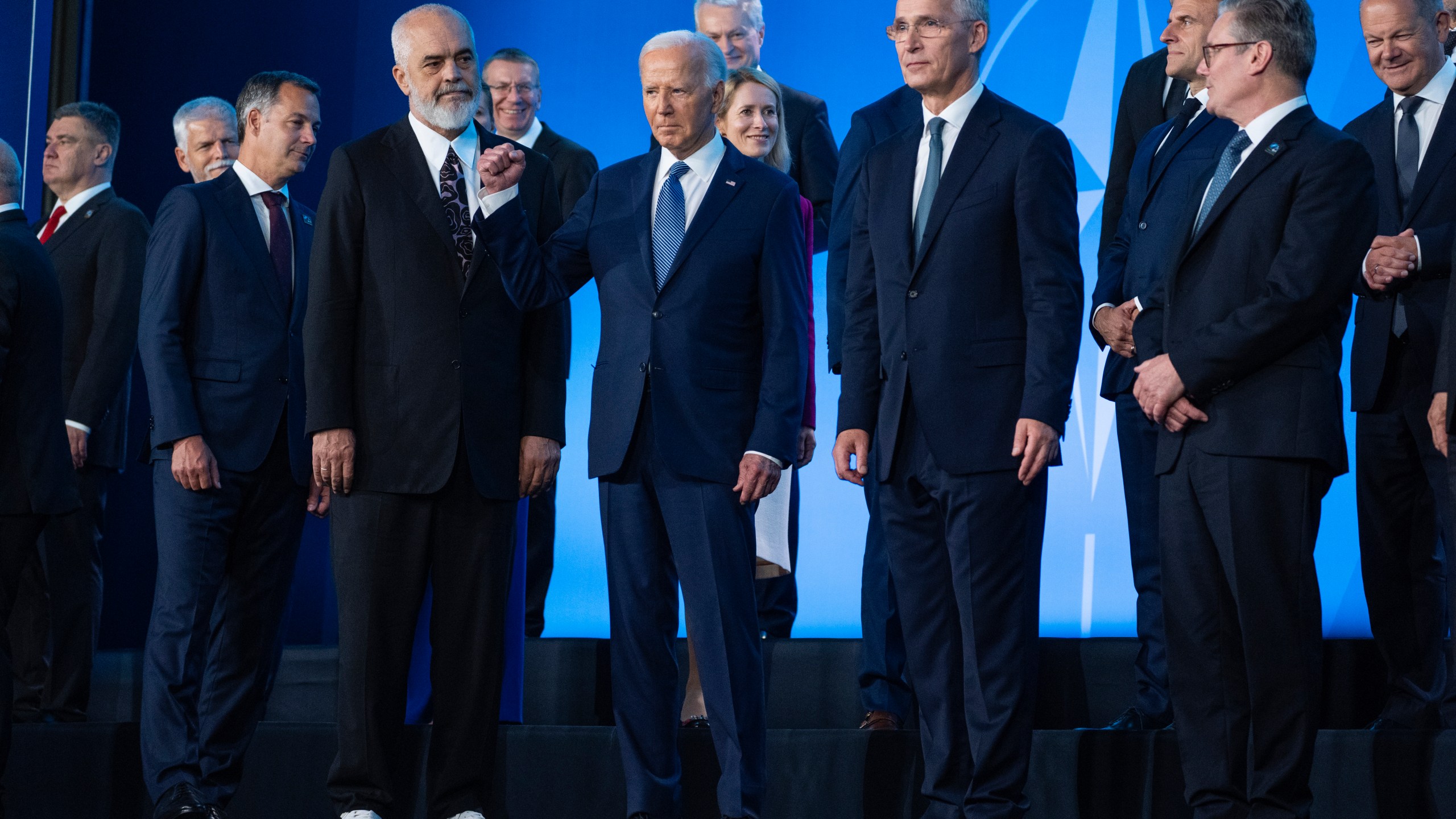 FILE - President Joe Biden pumps his fist during a family photo at the NATO Summit, Wednesday, July 10, 2024, in Washington. Biden’s withdrawal from the U.S. presidential race on Sunday, July 21, injects greater uncertainty into the world at a time Western leaders are grappling with two complicated wars in Ukraine and Gaza, a more assertive China in Asia and the rise of the far-right in Europe that threatens to erode democratic norms. (AP Photo/Evan Vucci, File)