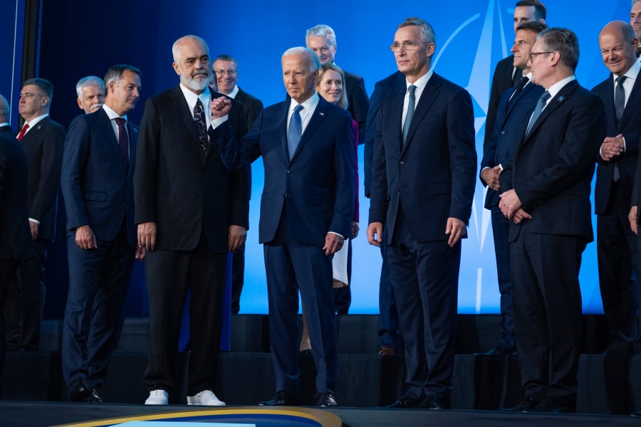 FILE - President Joe Biden pumps his fist during a family photo at the NATO Summit, Wednesday, July 10, 2024, in Washington. Biden’s withdrawal from the U.S. presidential race on Sunday, July 21, injects greater uncertainty into the world at a time Western leaders are grappling with two complicated wars in Ukraine and Gaza, a more assertive China in Asia and the rise of the far-right in Europe that threatens to erode democratic norms. (AP Photo/Evan Vucci, File)