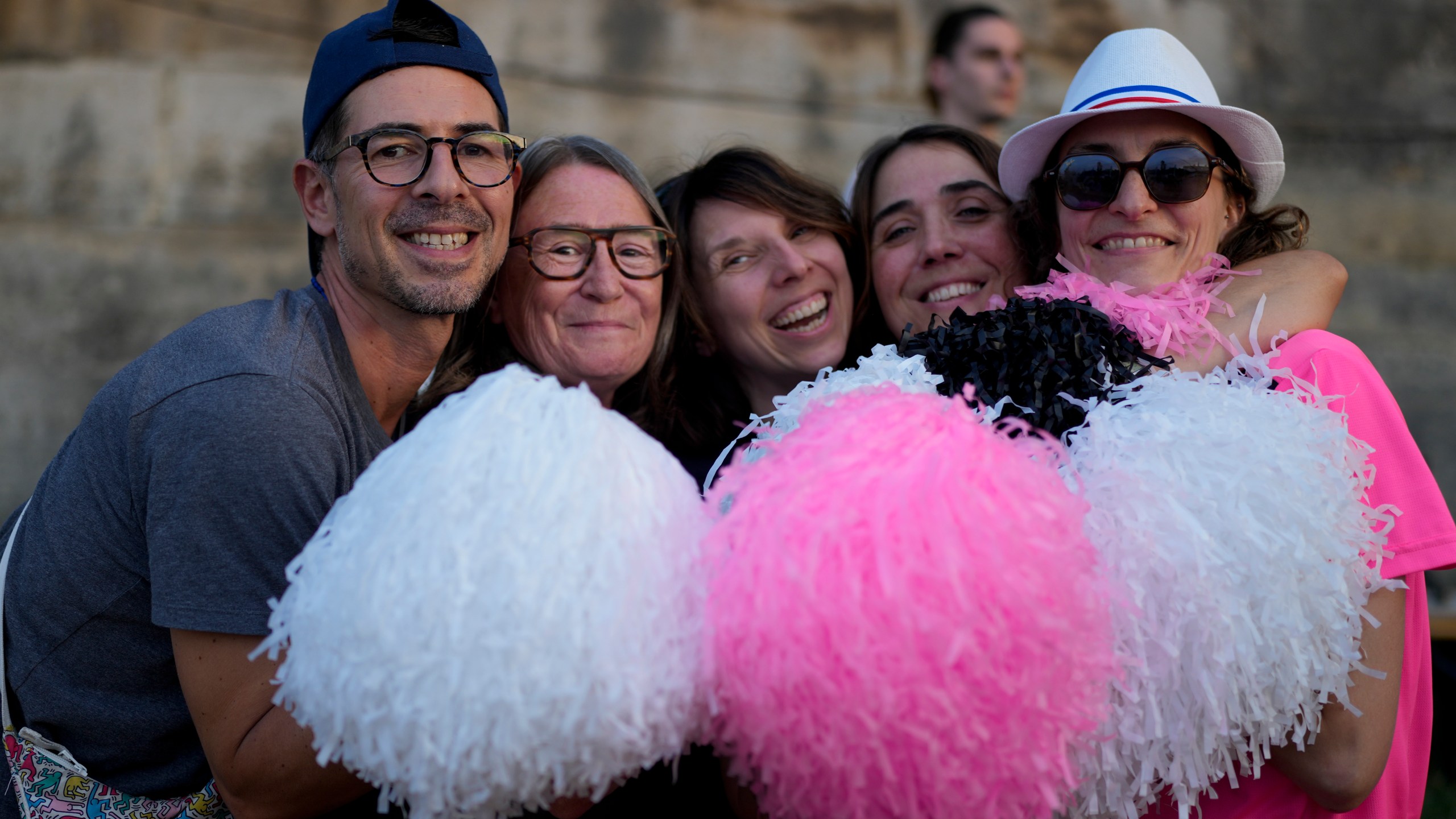 People pose for a photo as they attend the opening of Pride House, the safe space for the LGBT+ community of athletes, during the 2024 Summer Olympics, Monday, July 29, 2024, in Paris, France. (AP Photo/Natacha Pisarenko)