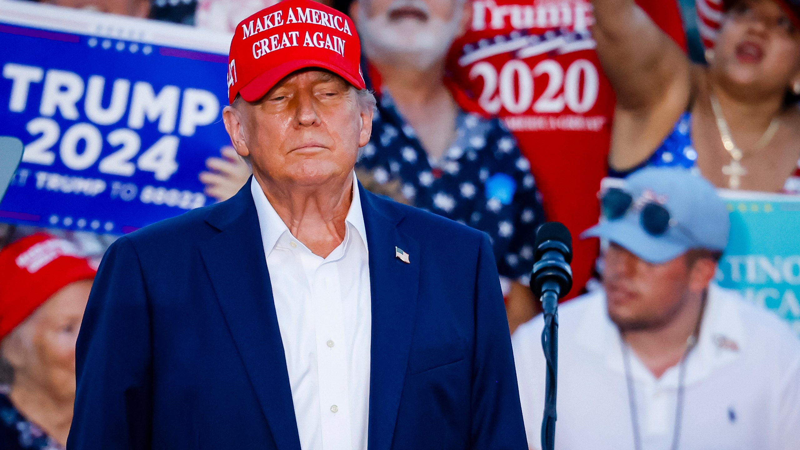 Donald Trump in a MAGA hat at a campaign event