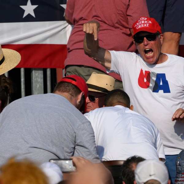 Attendees scatter after gunfire rang out during a campaign rally for Republican presidential candidate, former U.S. President Donald Trump.