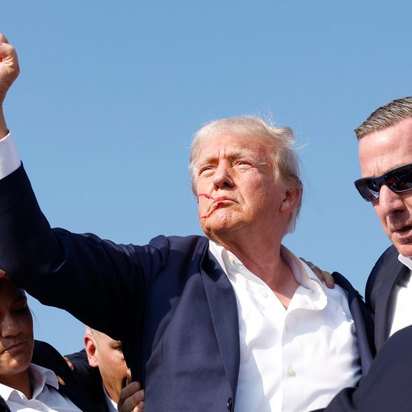 Former President Donald Trump is rushed offstage during a rally on July 13, 2024 in Butler, Pennsylvania.