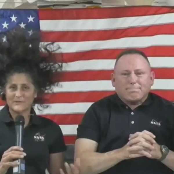 Boeing Starliner astronauts Butch Wilmore and Suni Williams, in front of an American flag aboard the International Space Station.