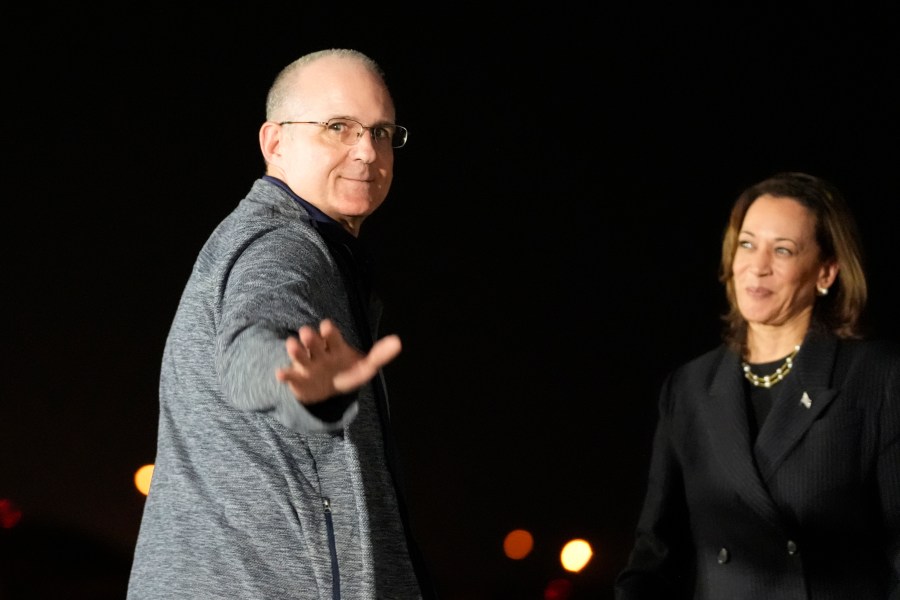 Vice President Kamala Harris, right, looks on at Paul Whelan at Andrews Air Force Base, Md., following his release as part of a 24-person prisoner swap between Russia and the United States, Thursday, Aug. 1, 2024. (AP Photo/Alex Brandon)