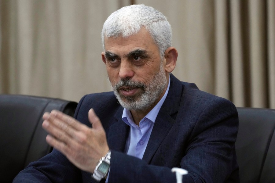 Yahya Sinwar, head of Hamas in Gaza, greets his supporters during a meeting with leaders of Palestinian factions at his office in Gaza City, Wednesday, April 13, 2022. (AP Photo/Adel Hana)