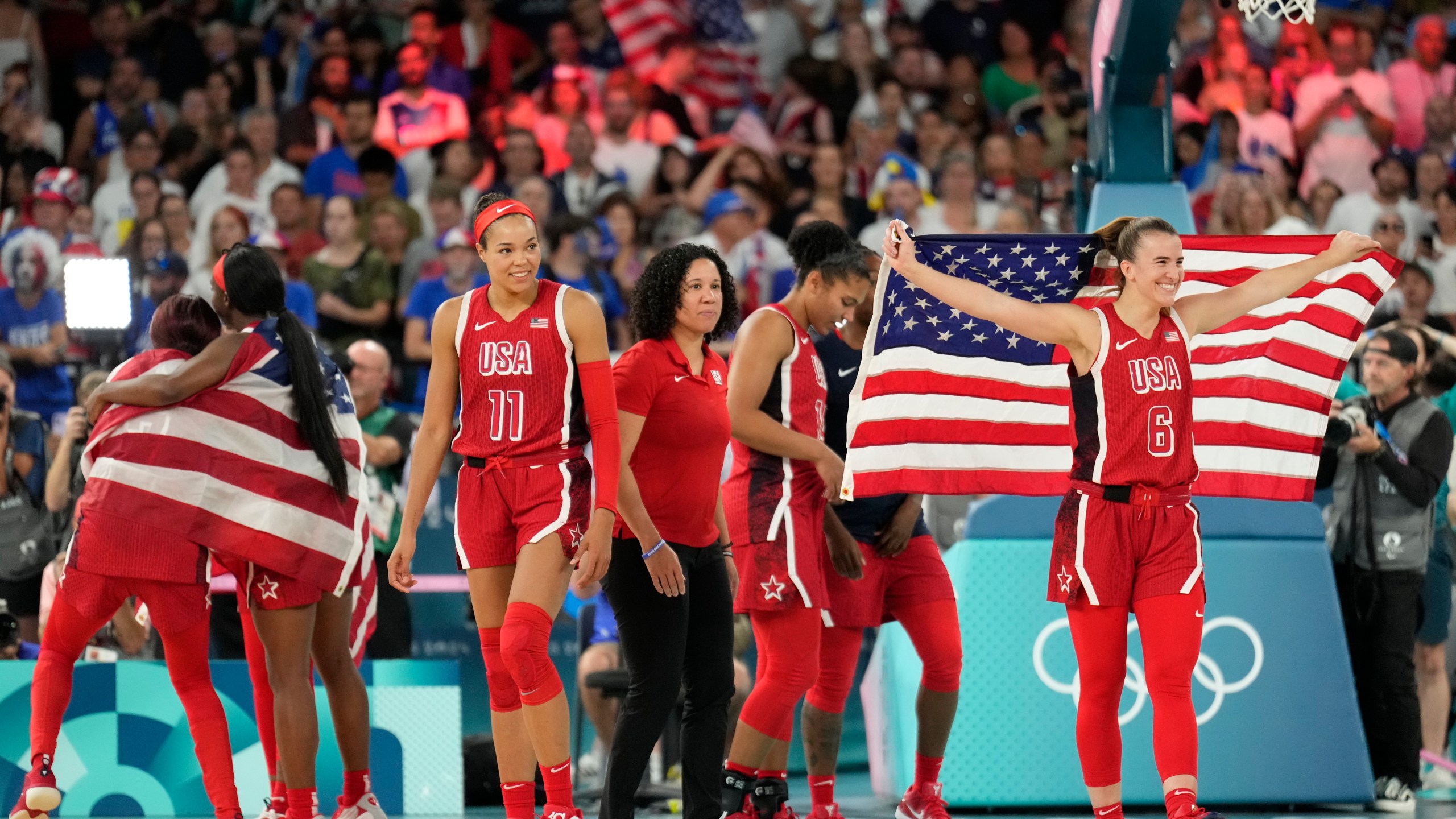 The United States team celebrates after a women's gold medal basketball game at Bercy Arena at the 2024 Summer Olympics, Sunday, Aug. 11, 2024, in Paris, France. (AP Photo/Mark J. Terrill)