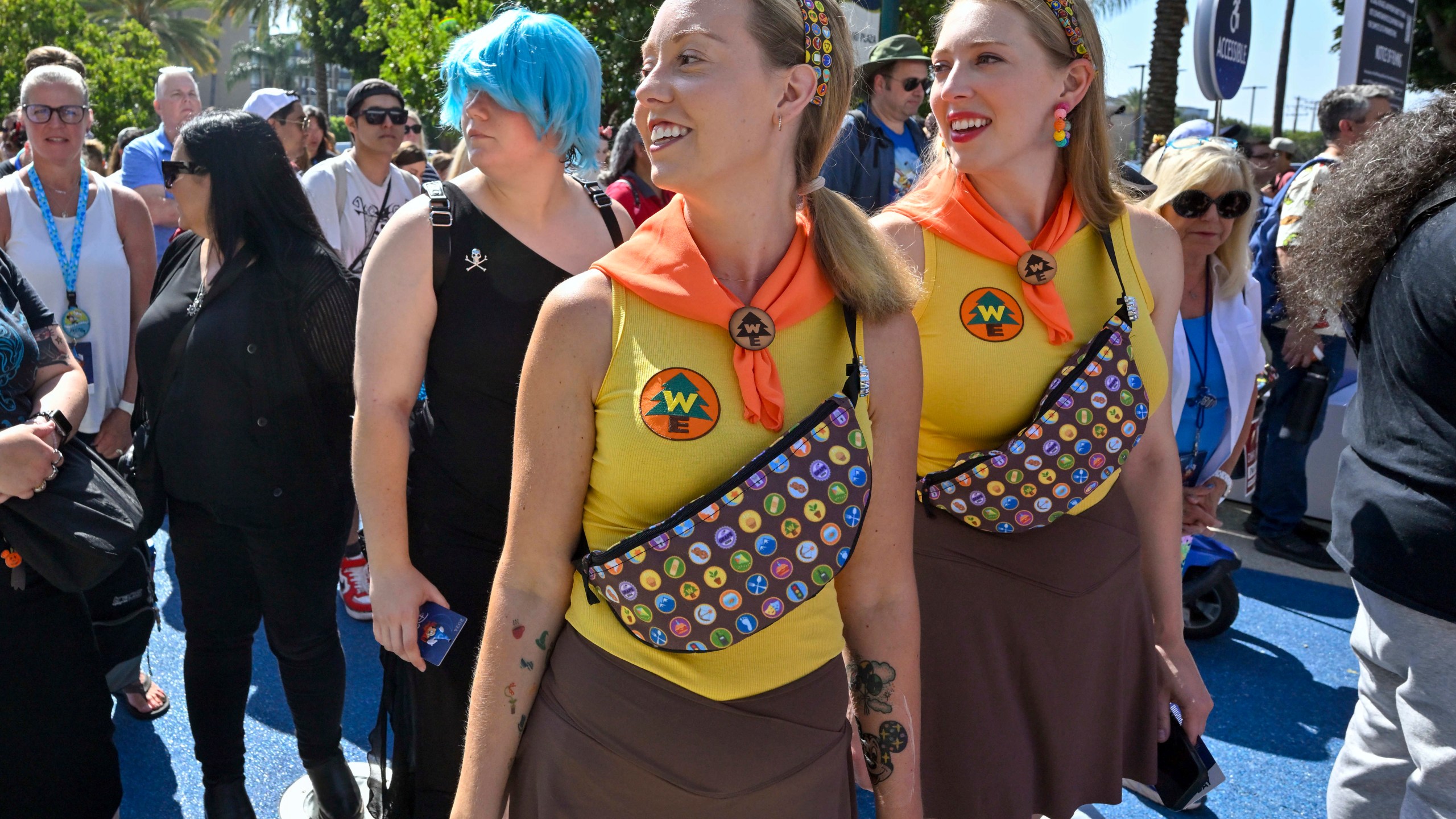 Tasha Black, left, and Raena Rubenstein are dressed as Wilderness Explorers from the Pixar movie Up as they wait to get into D23 during the Disney FanFest in Anaheim, Calif., Friday, August 9, 2024. (Jeff Gritchen/The Orange County Register via AP)