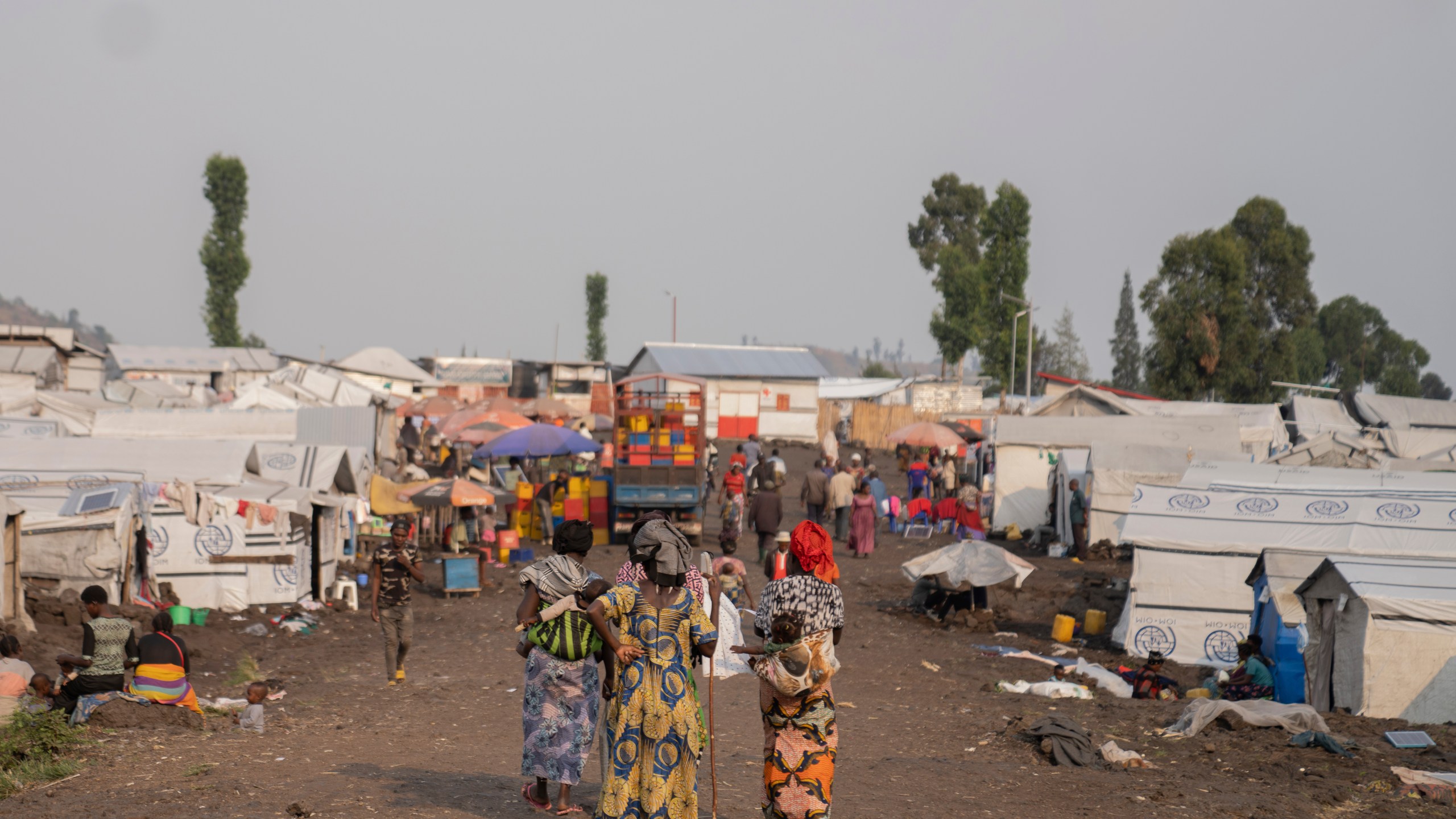 Women walk in the Bulengo refugee camp in Goma, Congo, after the World Health Organization had declared Thursday, Aug, 15, 2024, the increasing spread of mpox in Africa a global health emergency, warning the virus might ultimately spill across international borders. (AP Photo/Moses Sawasawa)