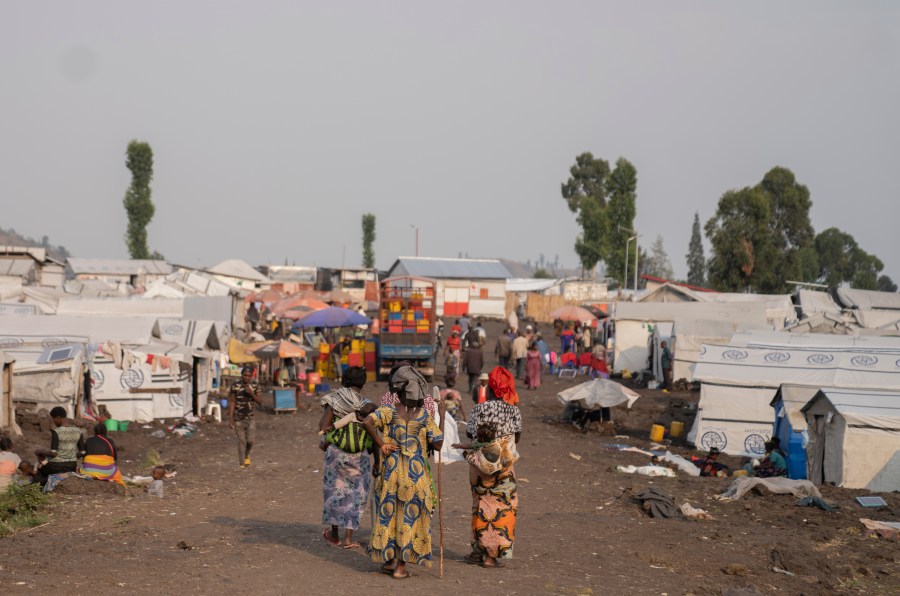 Women walk in the Bulengo refugee camp in Goma, Congo, after the World Health Organization had declared Thursday, Aug, 15, 2024, the increasing spread of mpox in Africa a global health emergency, warning the virus might ultimately spill across international borders. (AP Photo/Moses Sawasawa)