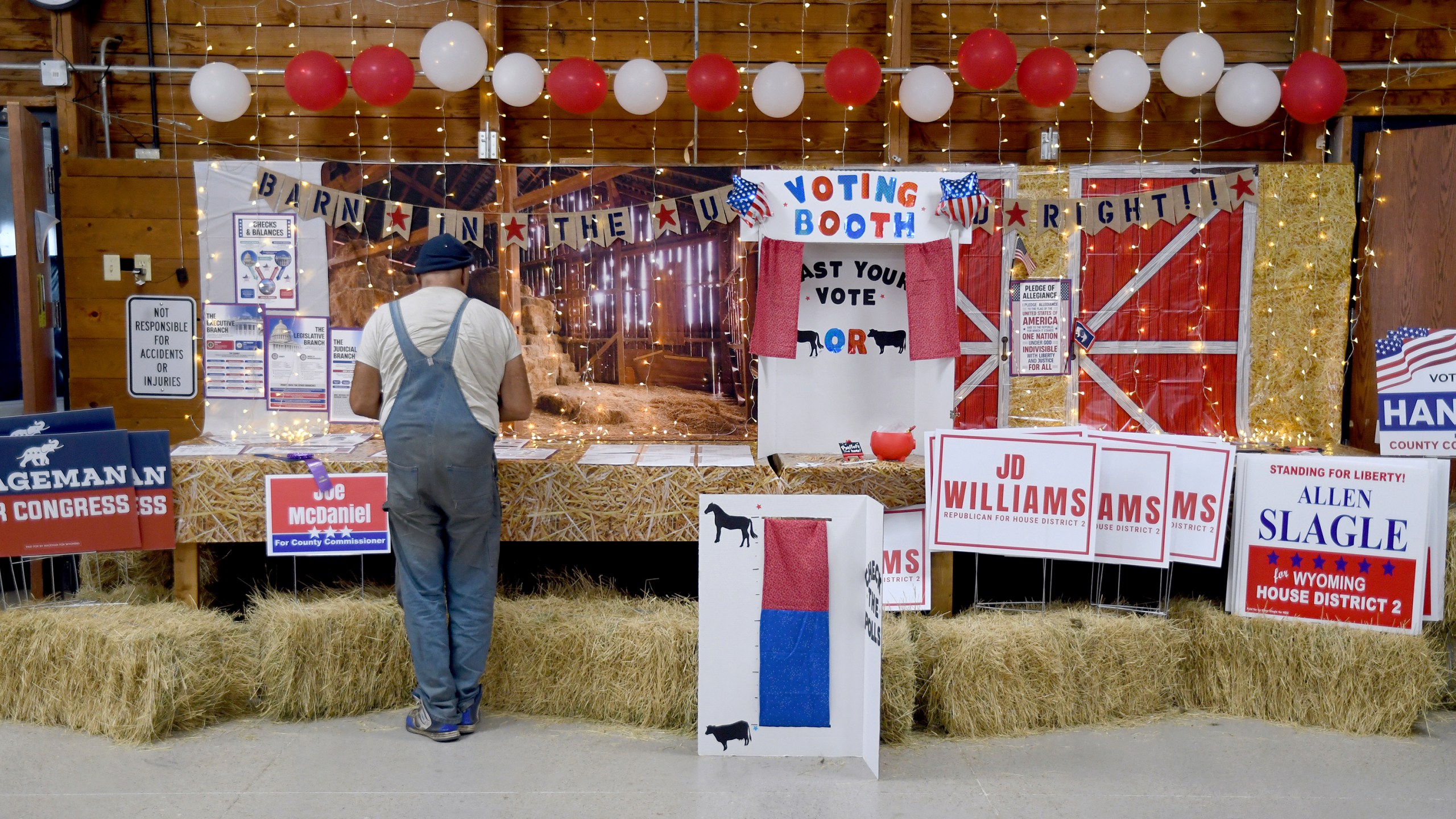 Pat Jordan, a registered Republican who describes himself as a progressive, looks at a get-out-the-vote display at the Niobrara County Fair in Lusk, Wyo., on July 31, 2024. (AP Photo/Thomas Peipert)