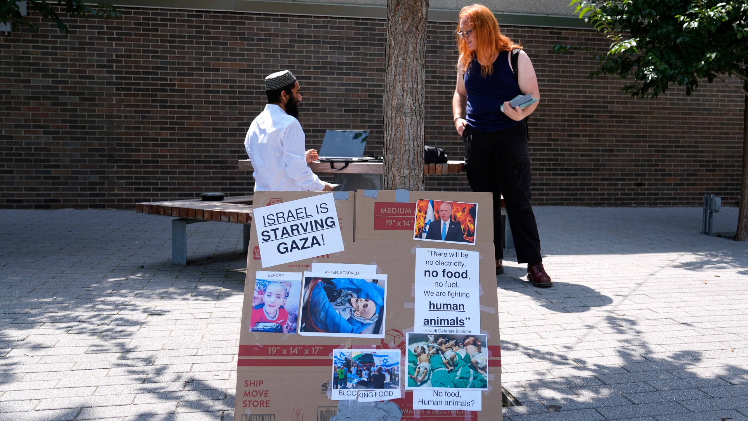 Activist Liz Rathburn, right, talks with University of Illinois-Chicago student Arsalan Zahid on campus Wednesday, Aug. 14, 2024, about two Pro-Palestinian marches, ahead of the Democratic National Convention in Chicago. (AP Photo/Charles Rex Arbogast)