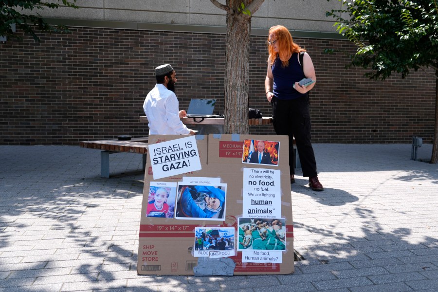 Activist Liz Rathburn, right, talks with University of Illinois-Chicago student Arsalan Zahid on campus Wednesday, Aug. 14, 2024, about two Pro-Palestinian marches, ahead of the Democratic National Convention in Chicago. (AP Photo/Charles Rex Arbogast)