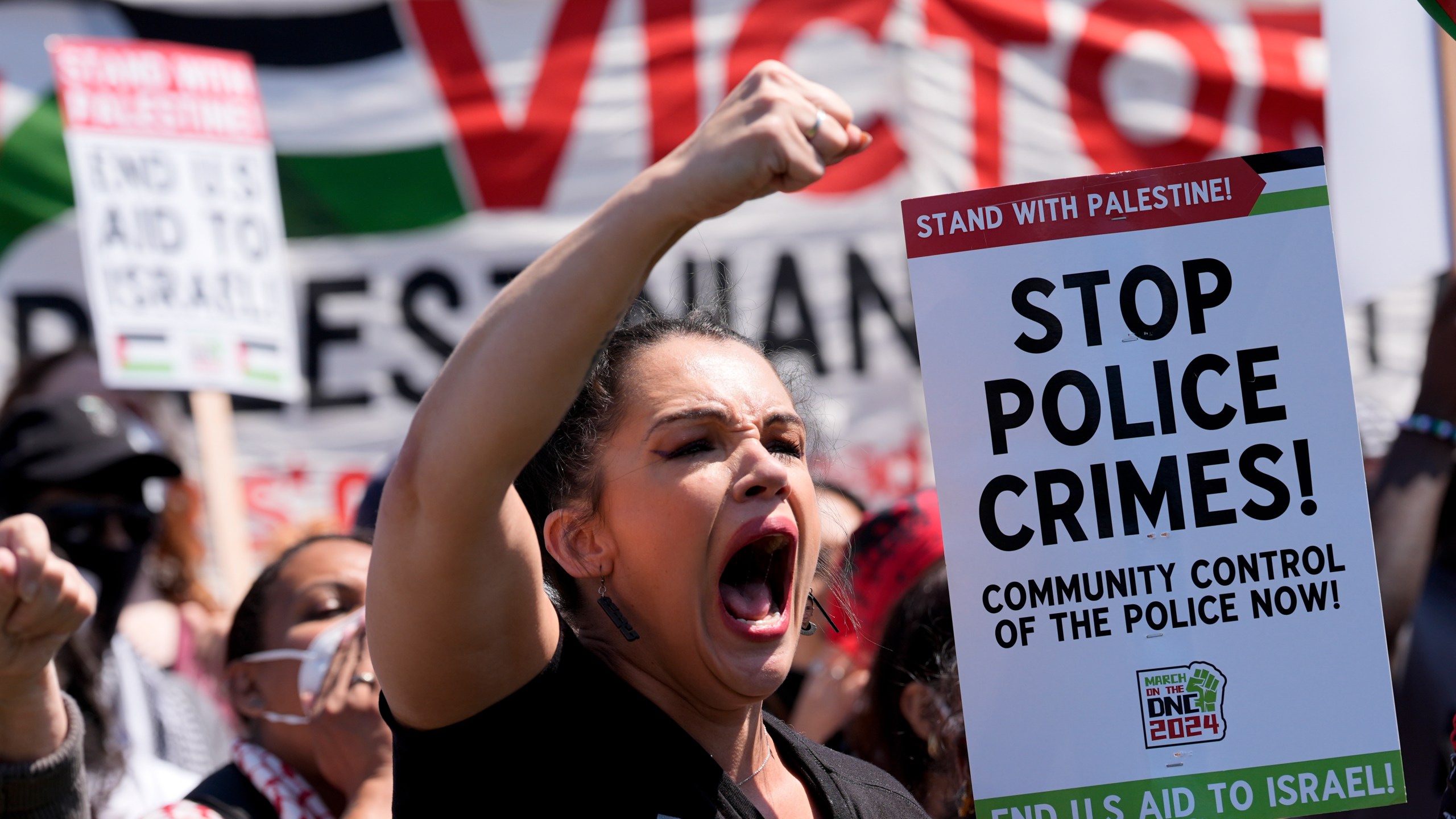 A protester yells during a demonstration before a march to the Democratic National Convention Monday, Aug. 19, 2024, in Chicago. (AP Photo/Alex Brandon)