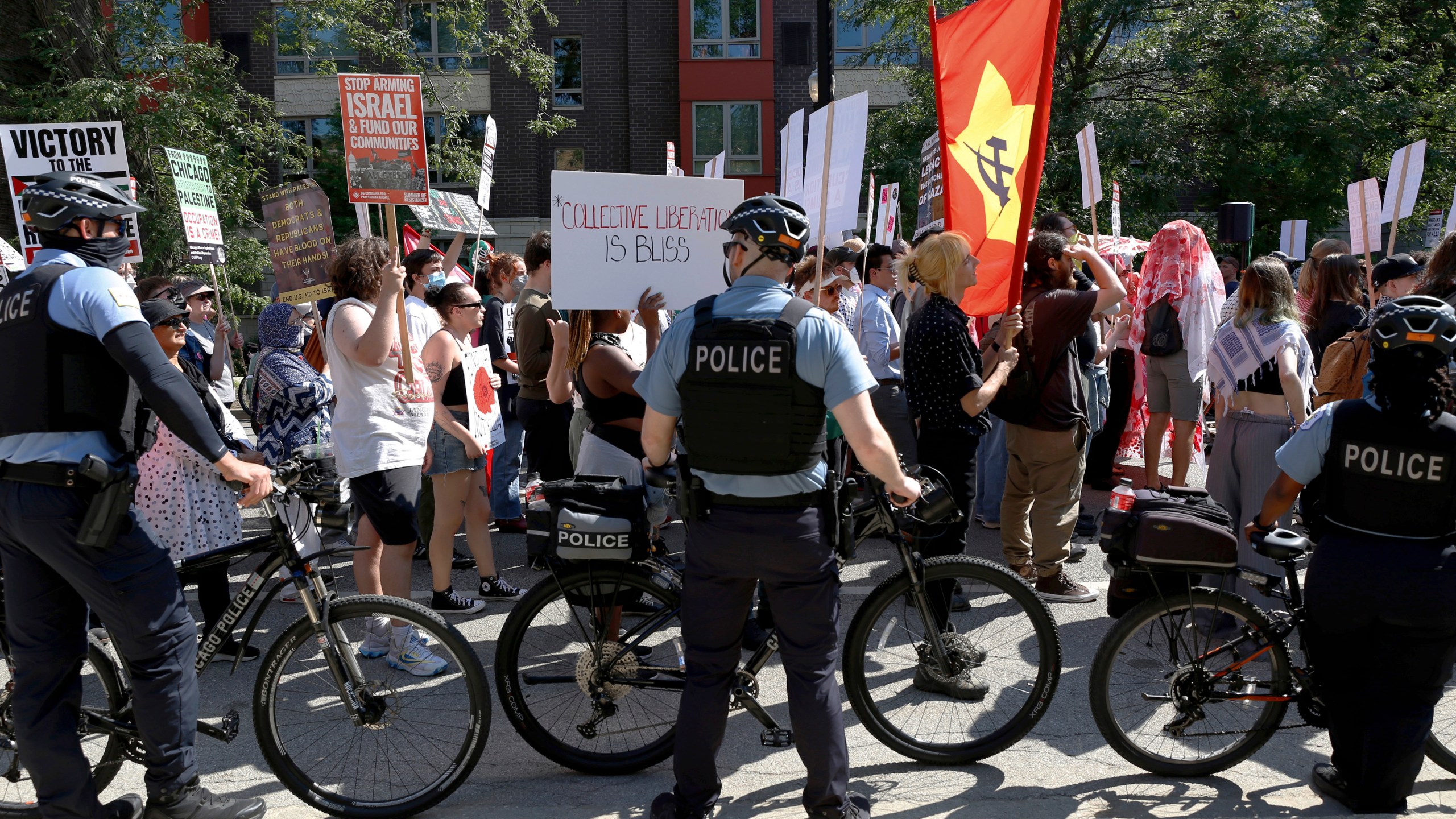 Chicago police use bicycles to make a rolling barrier along the March on DNC on Monday, Aug. 19, 2024, in Chicago. (AP Photo/Martha Irvine)