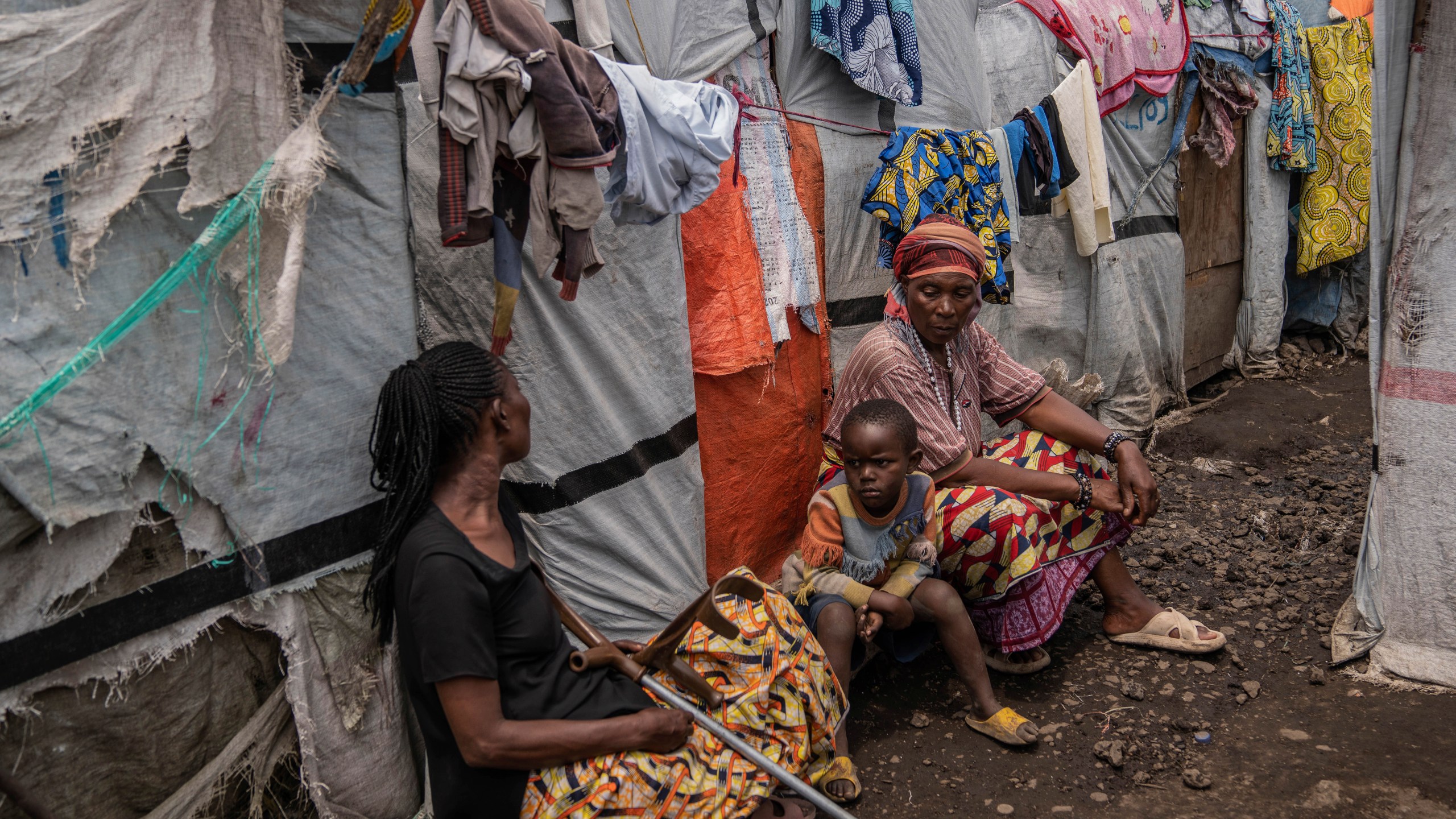 People sit at the Don Bosco refugee camp as Red Cross officials create awareness around mpox in Goma, Democratic Republic of Congo, Thursday, Aug. 22, 2023. (AP Photo/Moses Sawasawa)