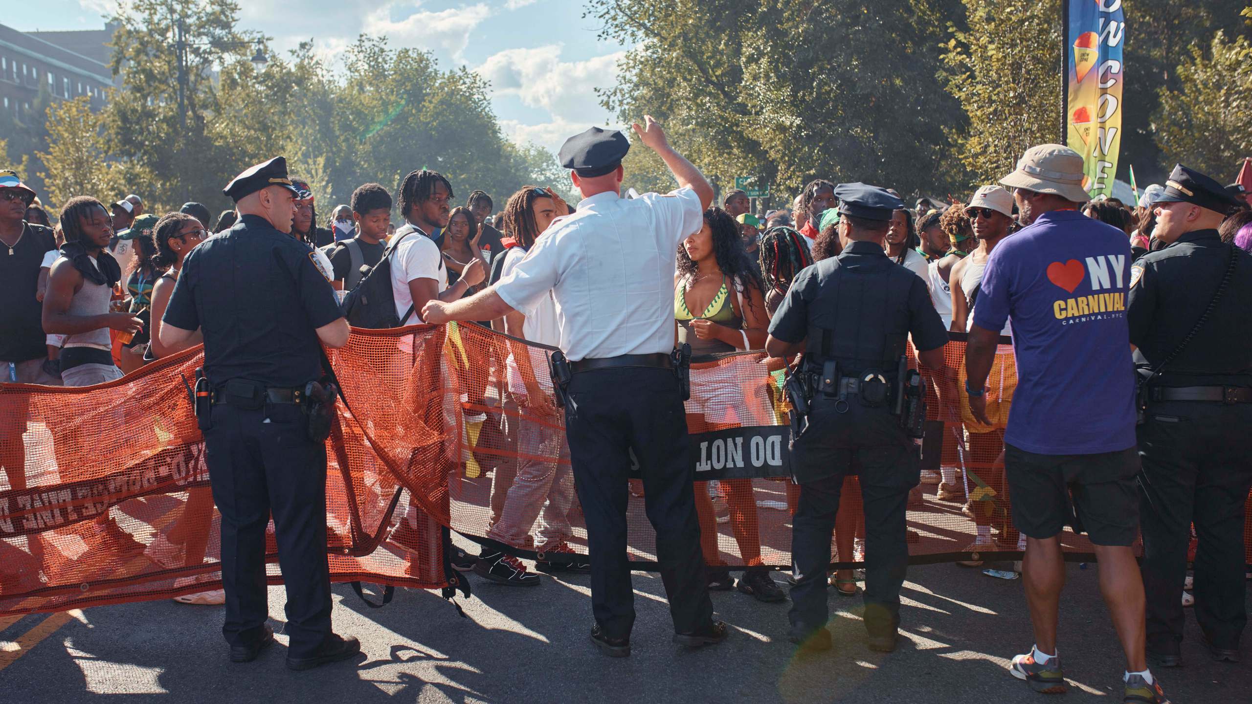 Police move revelers from the street after a shooting on Eastern Parkway, near the corner of Franklin Avenue, during the West Indian Day Parade on Monday, Sept. 2, 2024, in the Brooklyn borough of New York. (AP Photo/Andres Kudacki)