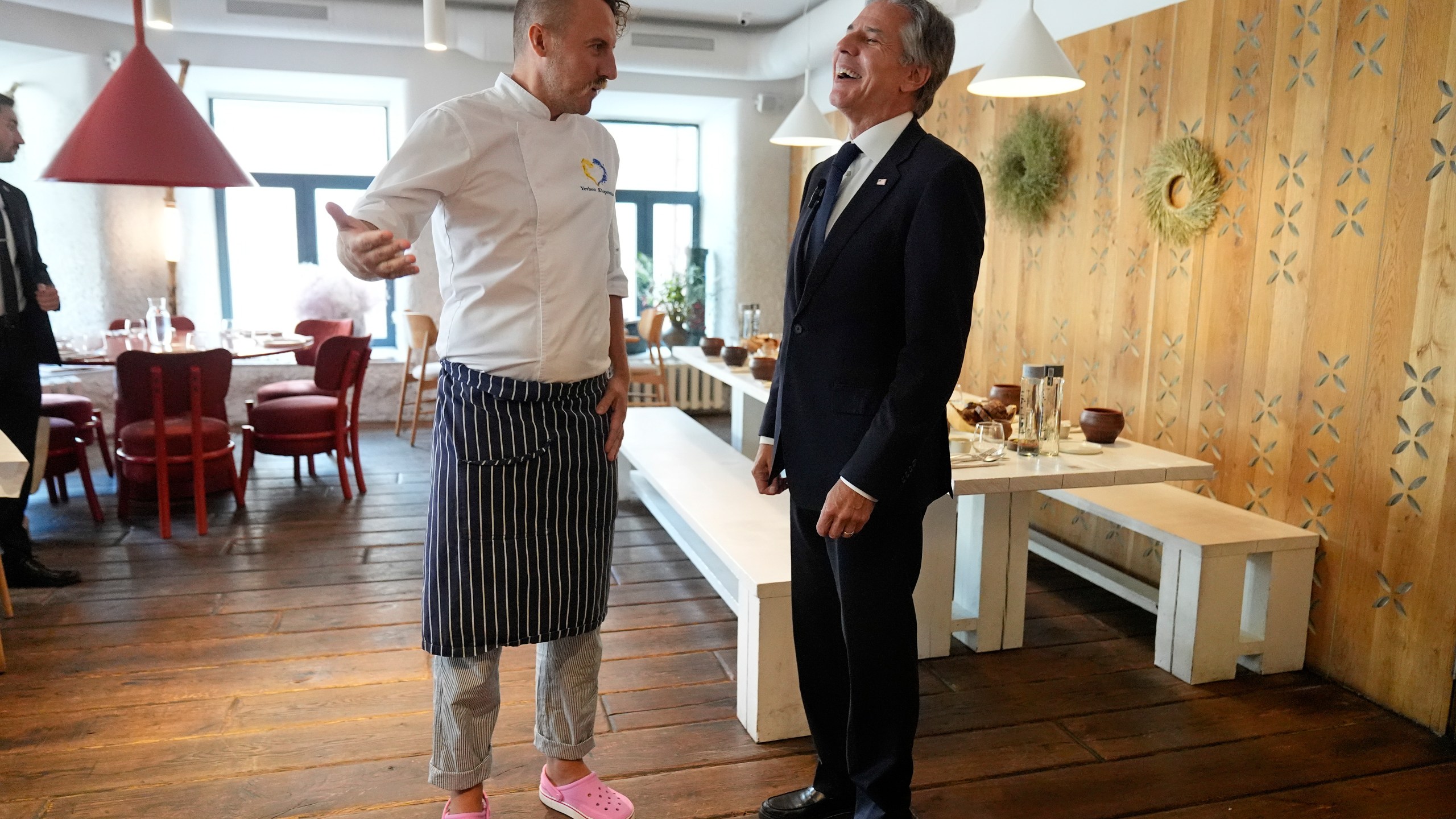 U. S. Secretary of State Antony Blinken speaks with chef Yevhen Klopotenko as he visits a restaurant in Kyiv, Ukraine, Wednesday, Sept. 11, 2024. (AP Photo/Mark Schiefelbein, Pool)