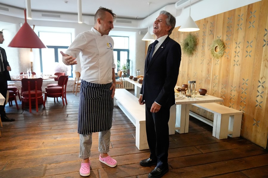 U. S. Secretary of State Antony Blinken speaks with chef Yevhen Klopotenko as he visits a restaurant in Kyiv, Ukraine, Wednesday, Sept. 11, 2024. (AP Photo/Mark Schiefelbein, Pool)