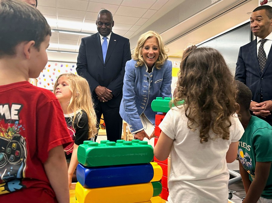 First lady Jill Biden, center, and Defense Secretary Lloyd Austin, left, watch four and five-year-olds build with blocks at a military early childhood education program at Maxwell Air Force Base in Alabama, Friday, Sept. 13, 2024. (AP Photo/Tara Copp)