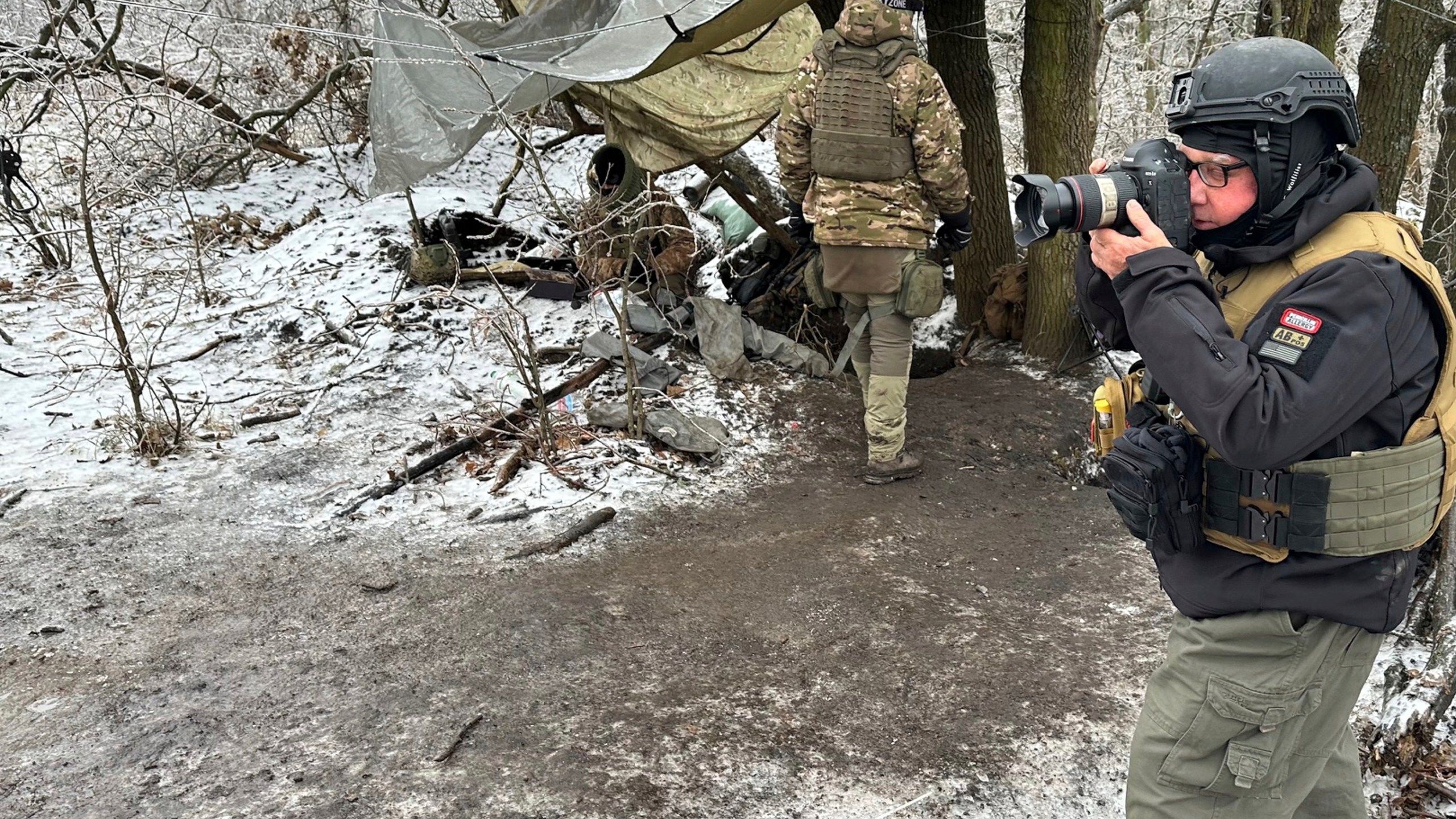 In this undated photo, Philanthropist Howard Buffett, who will help distribute his dad Warren Buffett’s fortune after his death, takes pictures in Donetsk Oblast, Ukraine, during one of his many trips to Ukraine since Russia invaded that country. (Oles Maliarevych via AP)