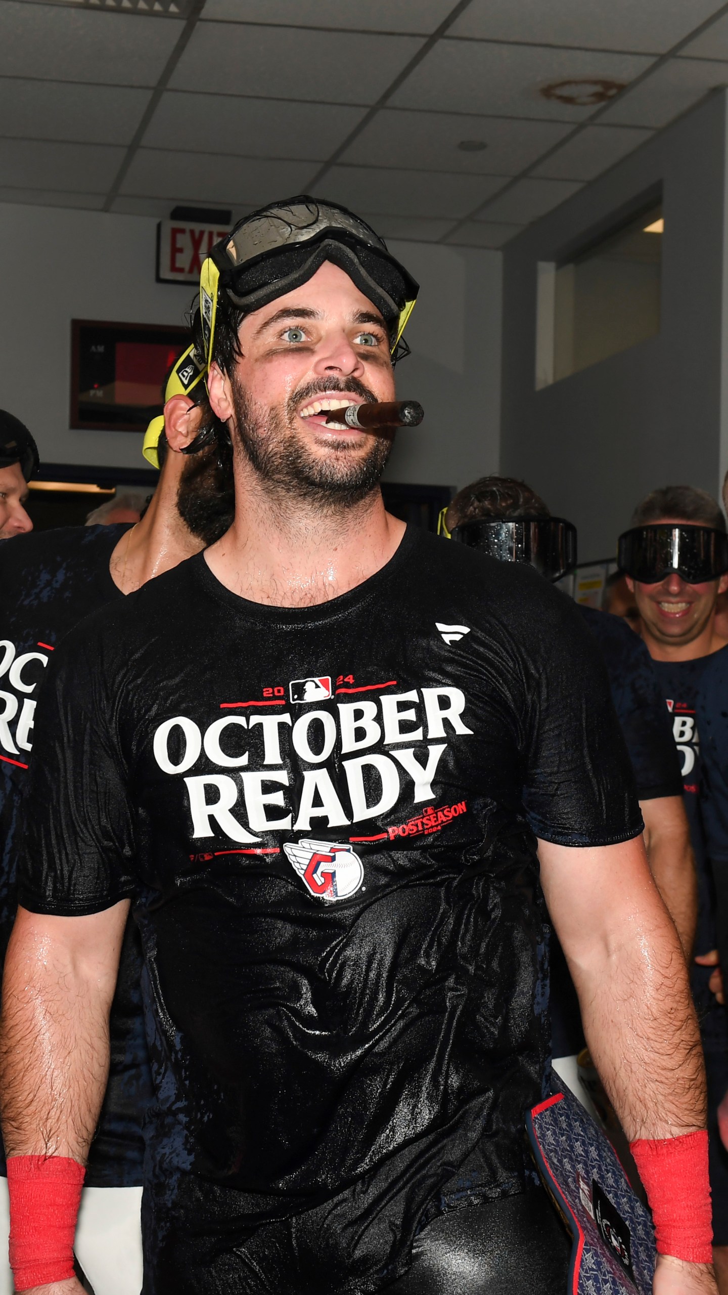 Cleveland Guardians' Austin Hedges celebrates in the clubhouse after they defeated the Minnesota Twins to clinch a baseball playoff berth, Thursday, Sept. 19, 2024, in Cleveland. (AP Photo/Nick Cammett)