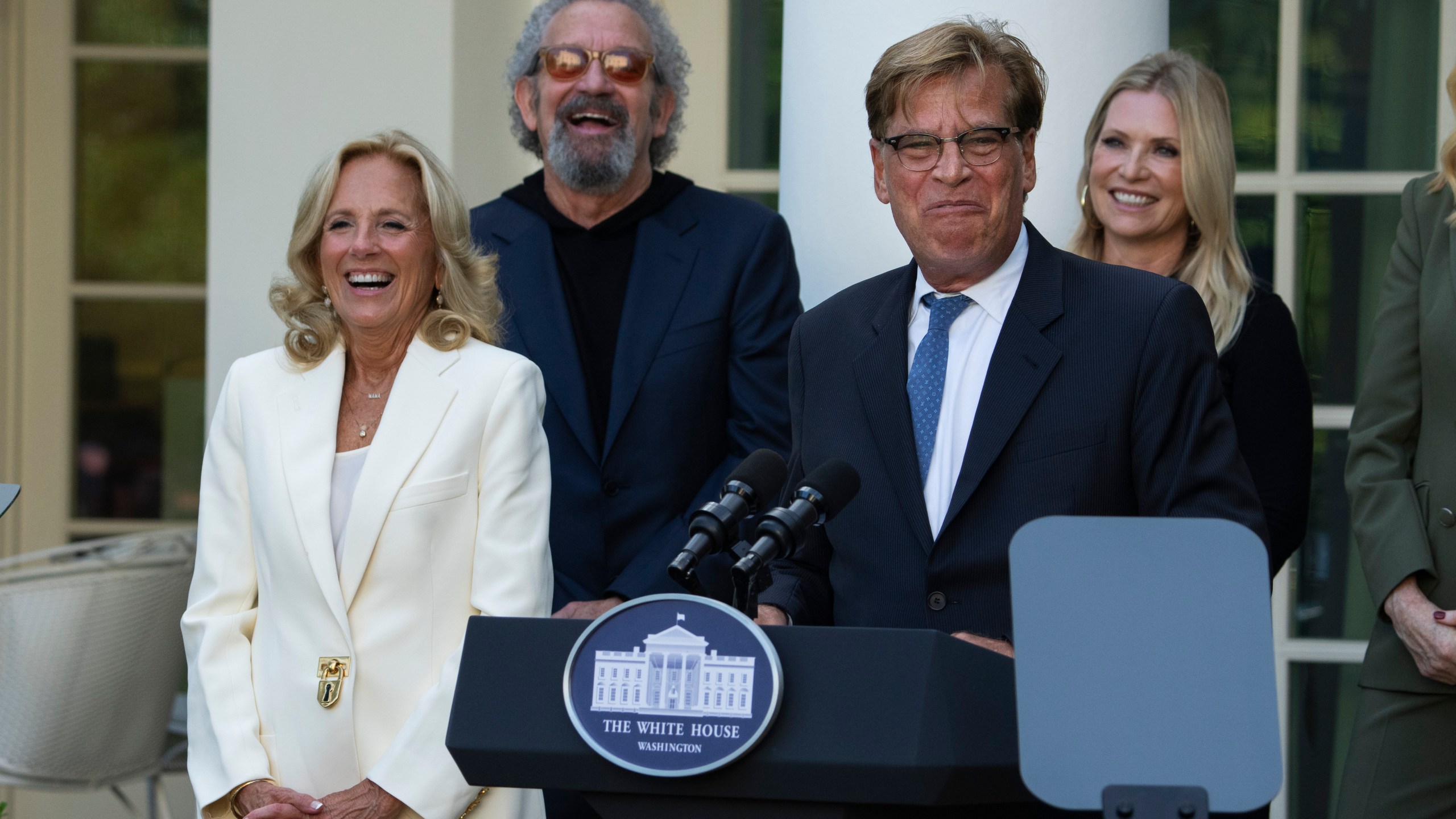 First lady Jill Biden, listens to Aaron Sorkin speak at an event on the Rose Garden at the White House to mark the 25th anniversary of the television series, The West Wing, Friday, Sept. 20, 2024, in Washington. (AP Photo/Manuel Balce Ceneta)