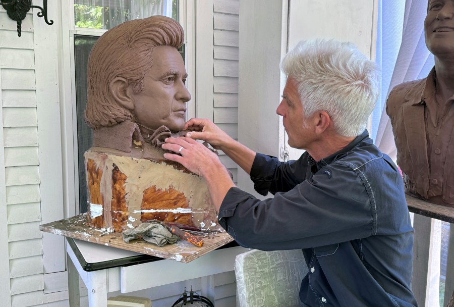 FILE - Artist Kevin Kresse, works on a clay bust of Johnny Cash, April 23, 2024 in Little Rock, Ark. Kresse's full sculpture of Cash will be unveiled at the U.S. Capitol as part of the Statuary Hall collection. (AP Photo/Mike Pesoli, File)