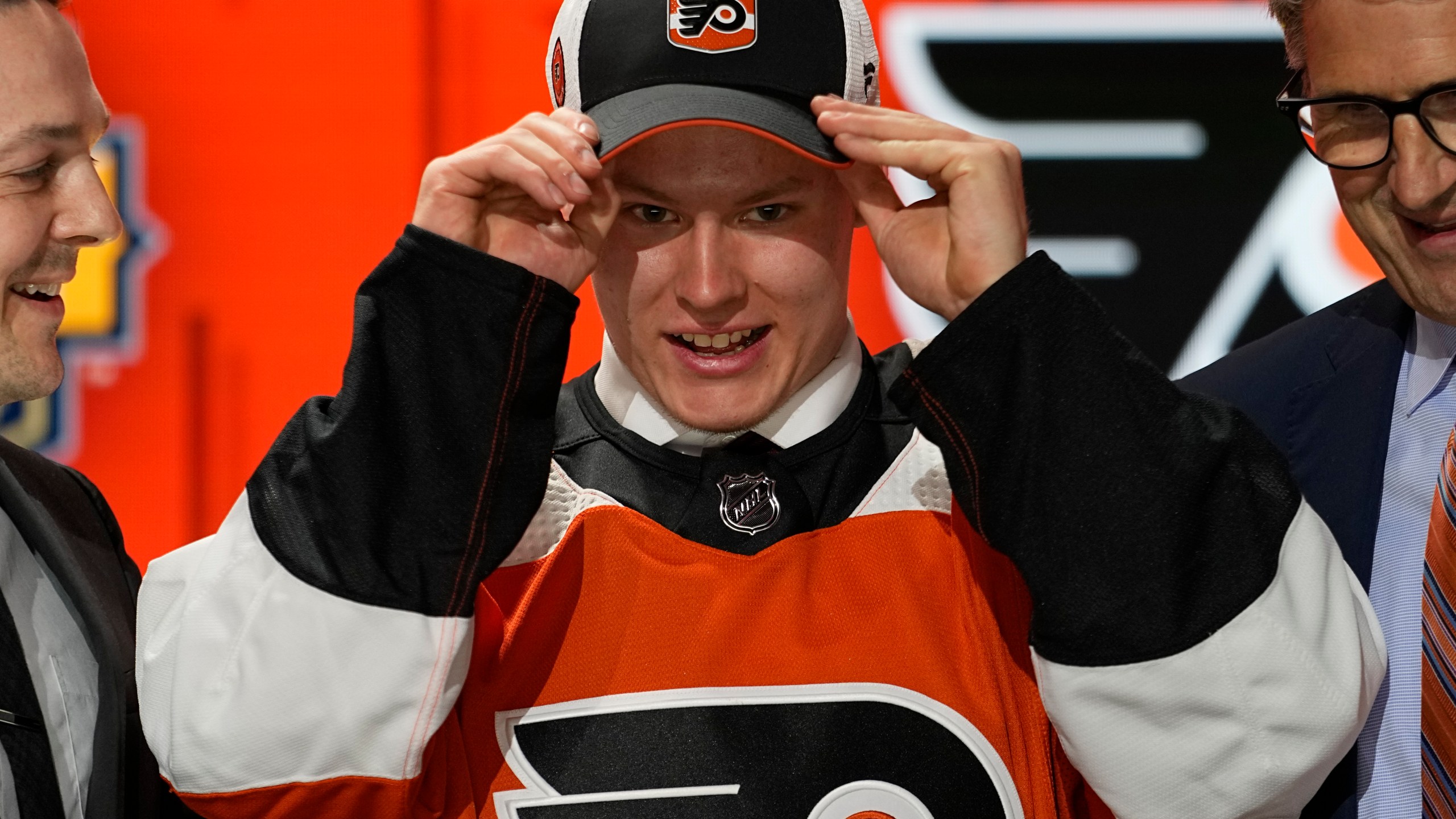 FILE - Matvei Michkov adjust his Philadelphia Flyers hat after being picked by the team during the first round of the NHL hockey draft Wednesday, June 28, 2023, in Nashville, Tenn. (AP Photo/George Walker IV, File)