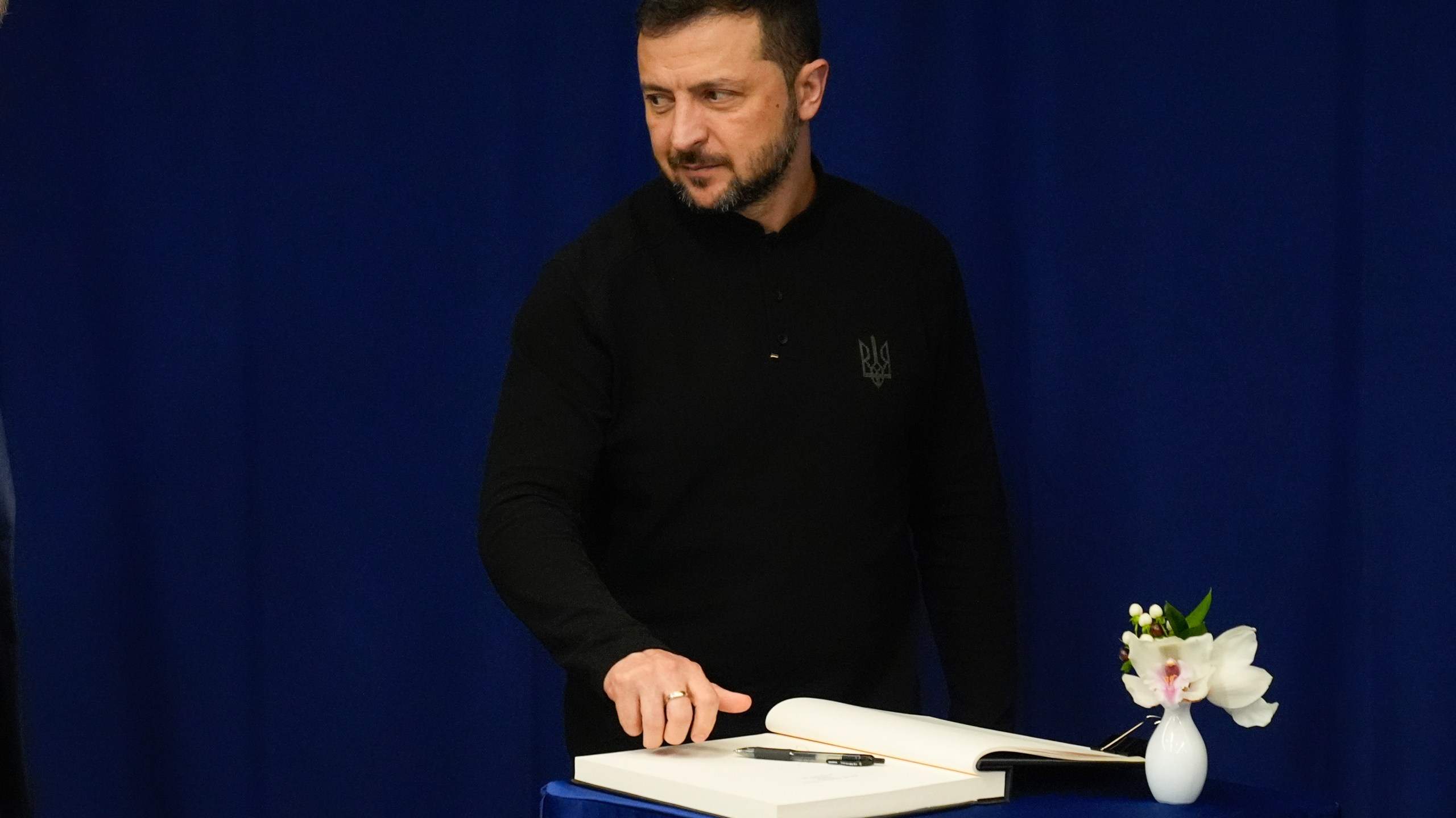 Ukraine President Volodymyr Zelenskyy, signs a guest book before his meeting with United Nations Secretary-General Antonio Guterres, Wednesday, Sept. 25, 2024 at U.N. headquarters. (AP Photo/Frank Franklin II)