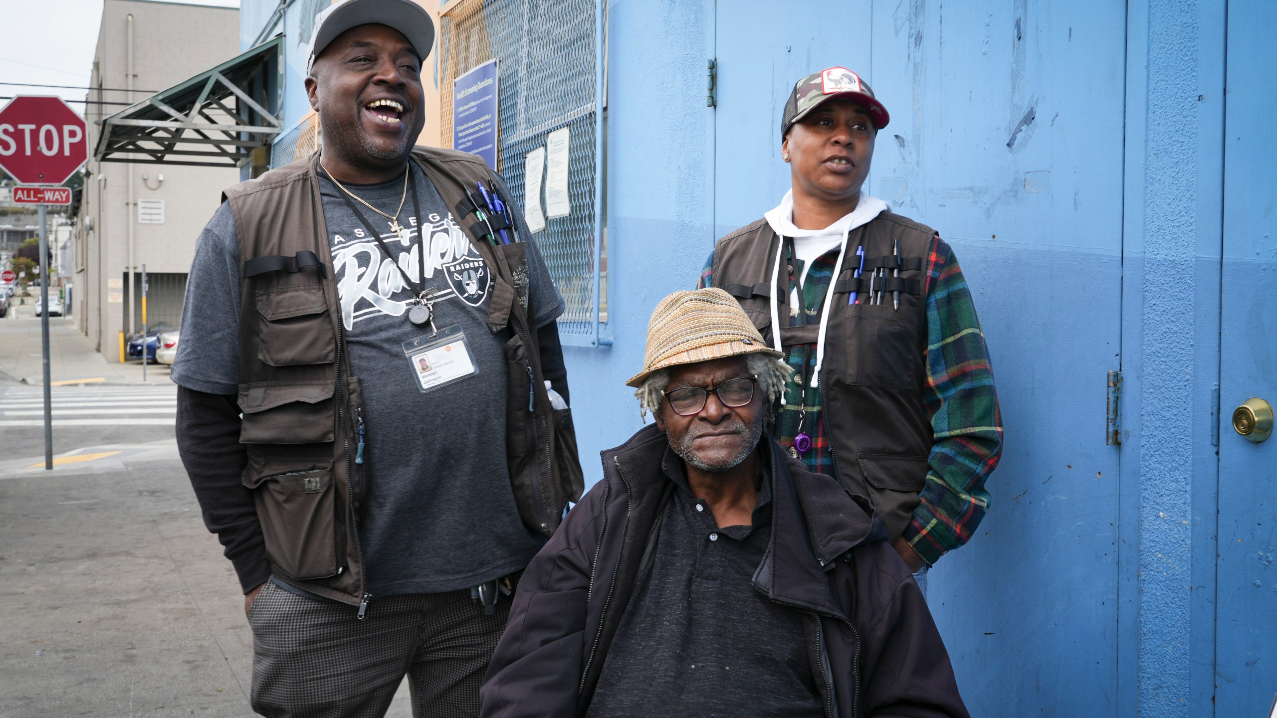 Homeless resident Larry James Bell, seated, is seen with Ventrell Johnson, left, and Jonice Pauley of the San Francisco Homeless Outreach Team, Tuesday, Sept. 10, 2024, in San Francisco. (AP Photo/Terry Chea)