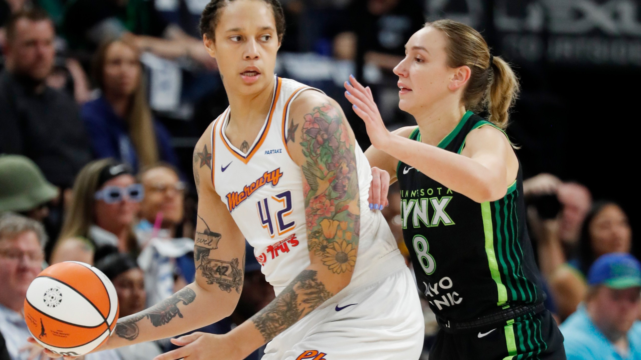 Phoenix Mercury center Brittney Griner (42) works around Minnesota Lynx forward Alanna Smith (8) in the first quarter of Game 2 of a WNBA basketball first-round playoff game, Wednesday, Sept. 25, 2024, in Minneapolis. (AP Photo/Bruce Kluckhohn)