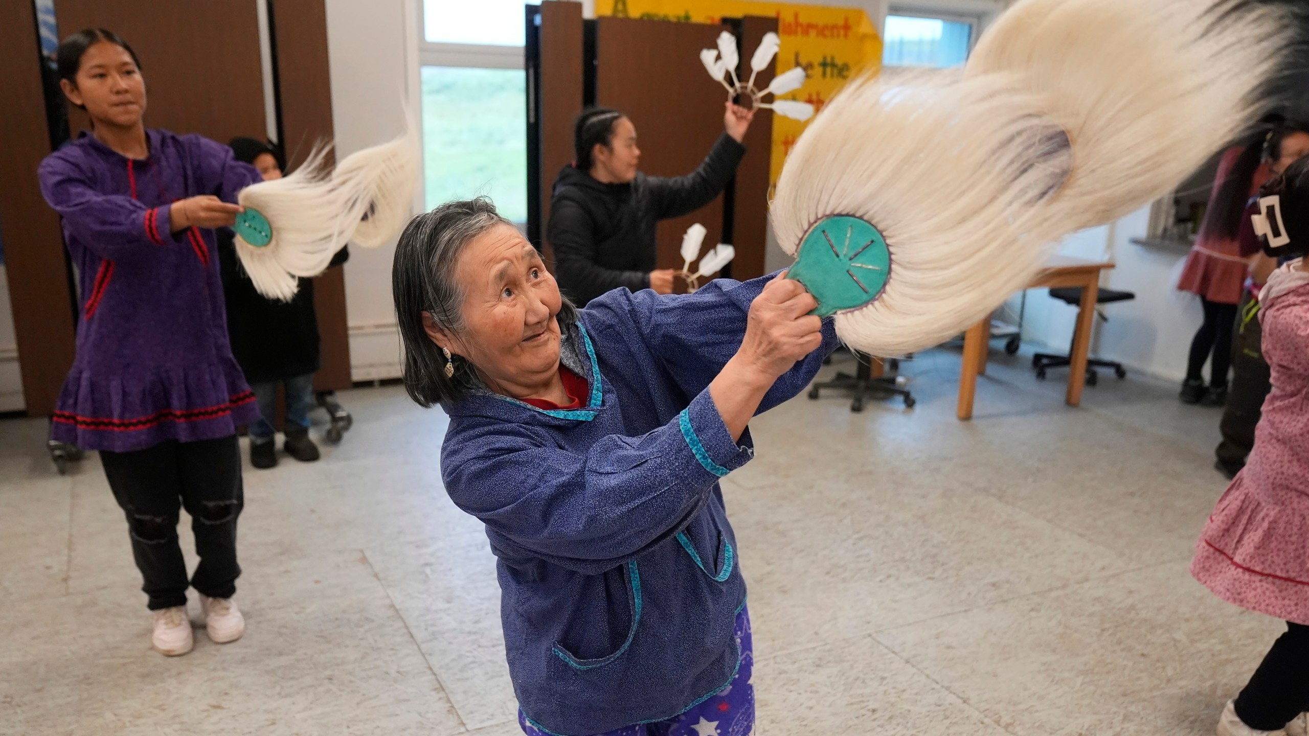 Marie Carl, 75, performs during an Indigenous drum and dance in Mertarvik, Alaska on Thursday, Aug. 15, 2024. (AP Photo/Rick Bowmer)