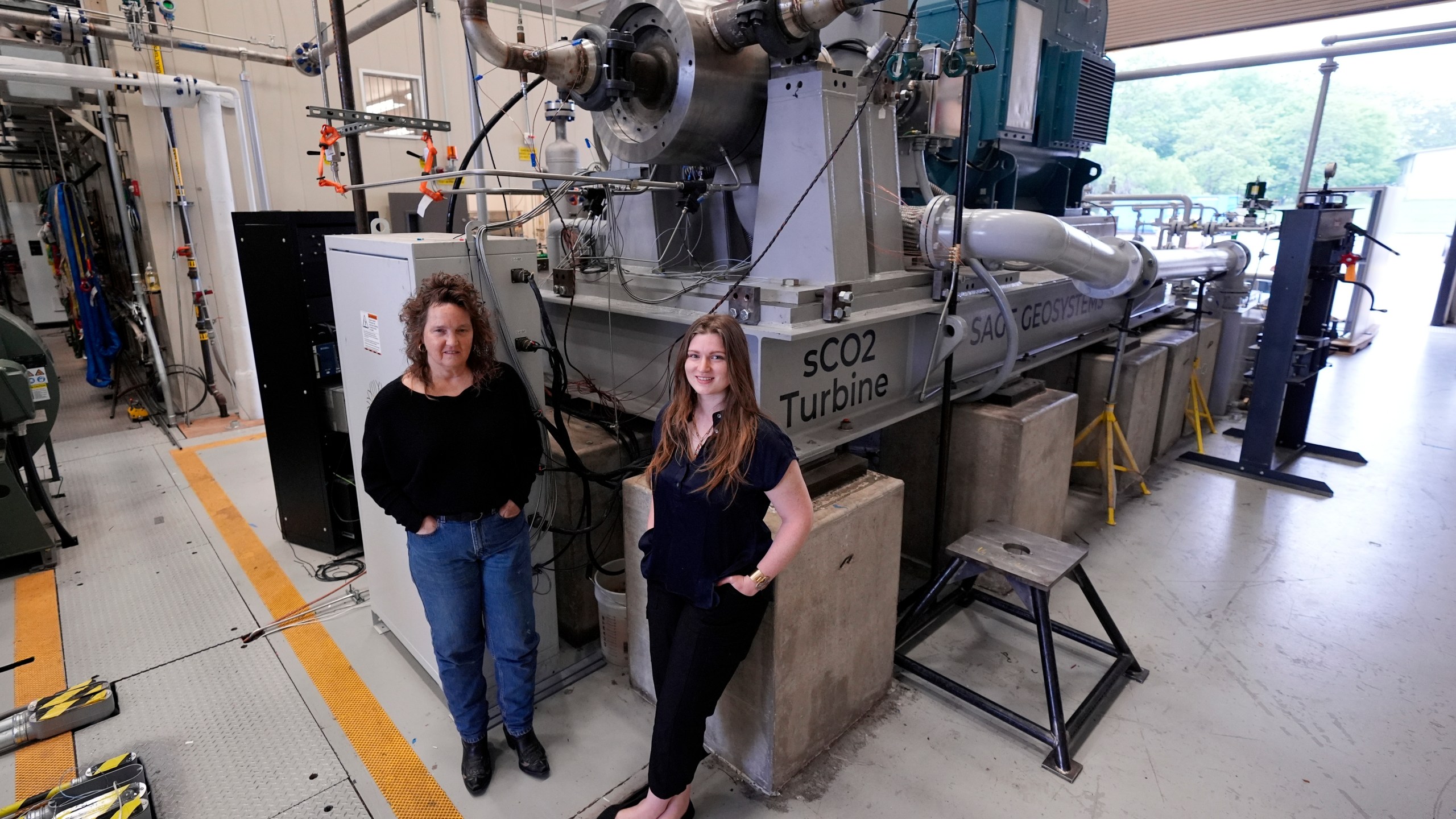 Cindy Taff, left, and Brianna Byrd with Sage Geosystems, a startup that aims to make clean electricity, visit Southwest Research Institute where testing and research is taking place in San Antonio, Monday, April 1, 2024. (AP Photo/Eric Gay)