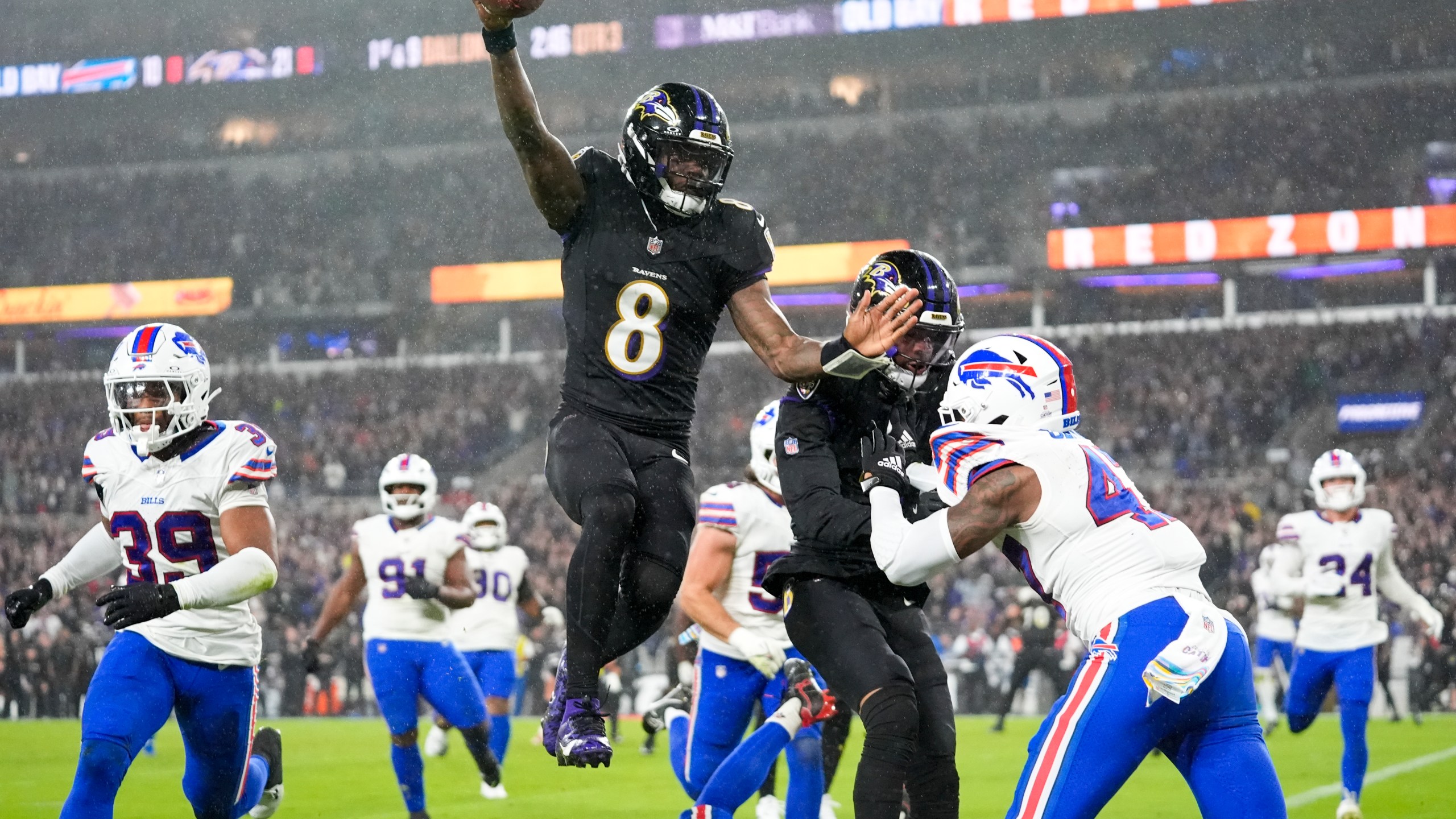 Baltimore Ravens quarterback Lamar Jackson (8) scores a touchdown against the Buffalo Bills during the second half of an NFL football game, Sunday, Sept. 29, 2024, in Baltimore. (AP Photo/Stephanie Scarbrough)