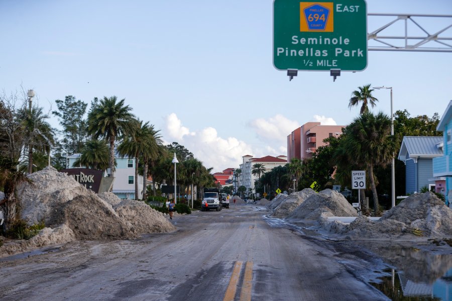 Crews work to clean up the tons of sand and debris pushed onto Gulf Boulevard from Hurricane Helene storm surge, Saturday, Sept. 28, 2024, in Madeira Beach, Fla. (Luis Santana/Tampa Bay Times via AP)