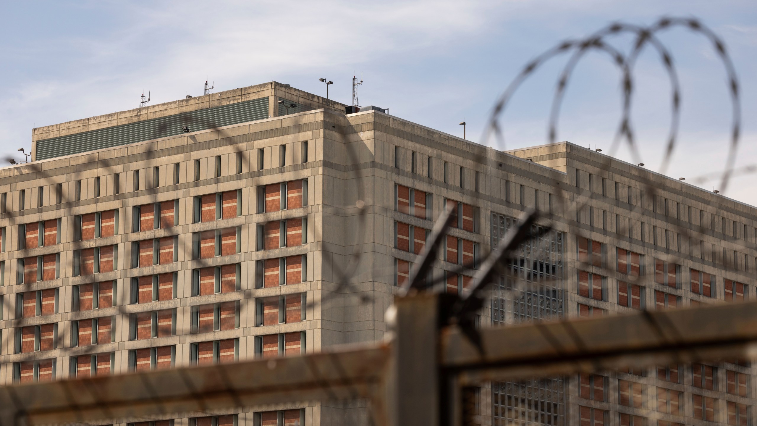 The Metropolitan Detention Center is seen through barb wire in the Sunset Park neighborhood of the Brooklyn borough of New York, Thursday, Sept. 19, 2024. (AP Photo/Yuki Iwamura)