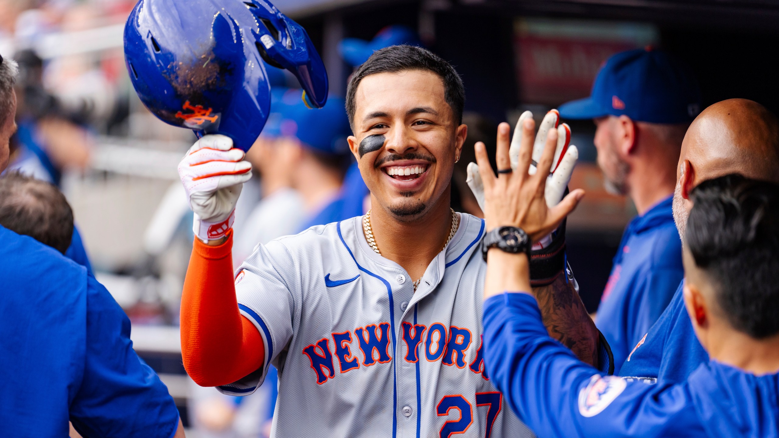 New York Mets' Mark Vientos celebrates in the dugout after scoring in the eighth inning of a baseball game against the Atlanta Braves, Monday, Sept. 30, 2024, in Atlanta. (AP Photo/Jason Allen)