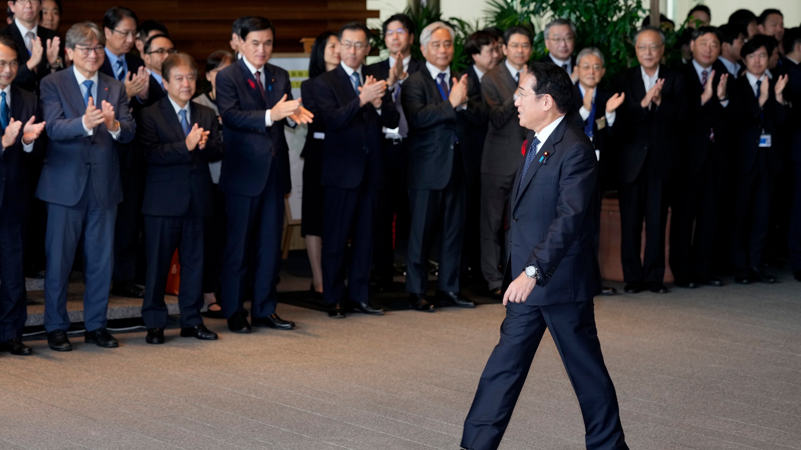 Japan's outgoing Prime Minister Fumio Kishida, front, is seen off as he leaves the prime minister's office in Tokyo Tuesday, Oct. 1, 2024. (AP Photo/Hiro Komae)