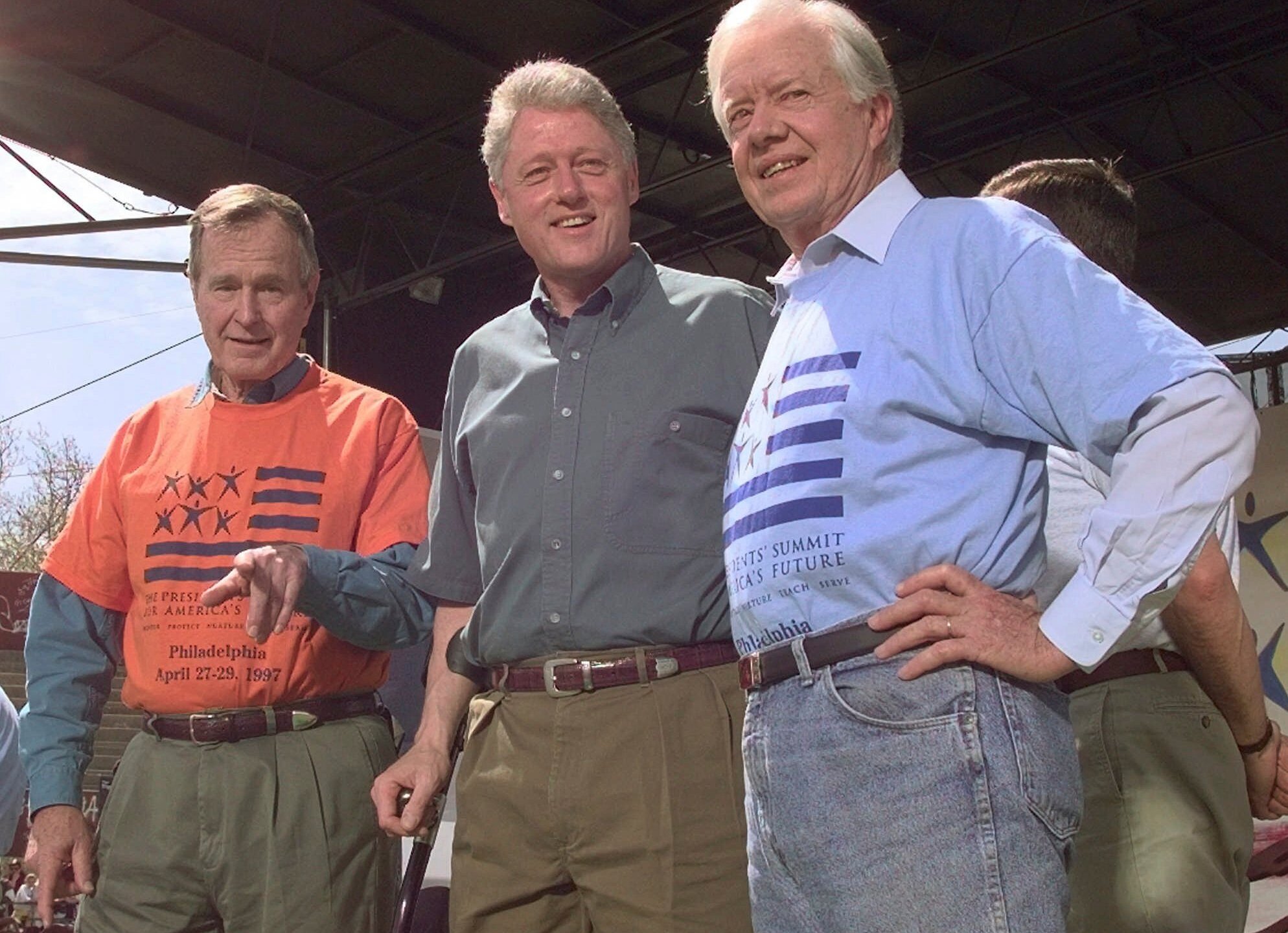 FILE - Former Presidents George Bush, left, and Jimmy Carter, right, stand with President Clinton during a kick-off rally for the President's volunteer summit at Marcus Foster Stadium in Philadelphia, PA., April 27, 1997. (AP Photo/Greg Gibson, File)