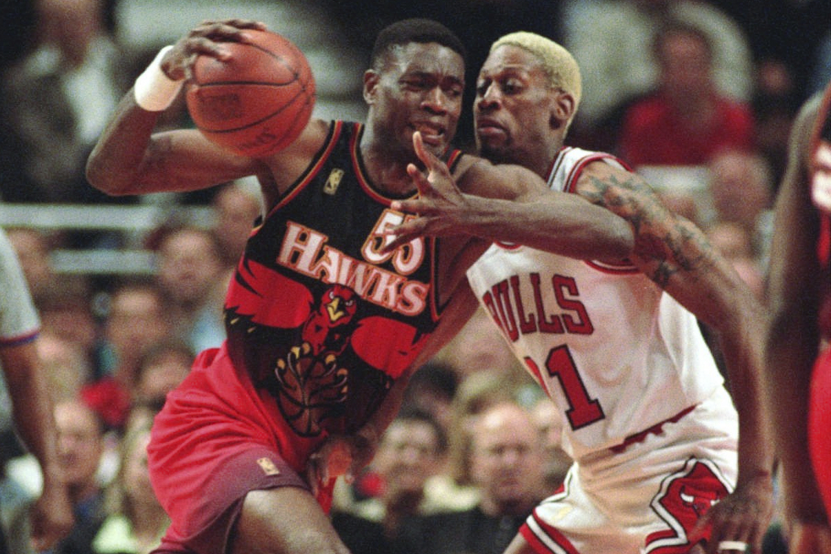 FILE - The Atlanta Hawks' Dikembe Mutombo, left, drives to the hoop against the Chicago Bulls' Dennis Rodman during the second quarter of their playoff game Thursday, May 8, 1997, in Chicago. (AP Photo/Michael S. Green, File)