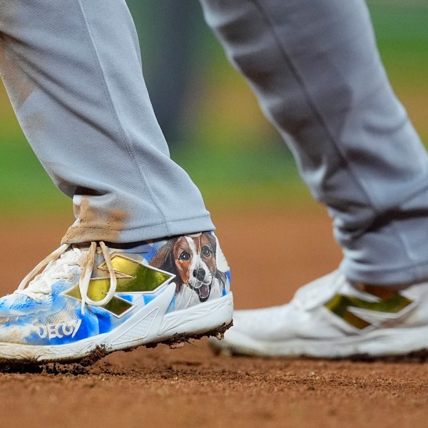 Los Angeles Dodgers' Shohei Ohtani wears a pair of spikes adorned with a photograph of his dog, Decoy, in the fifth inning of a baseball game against the Colorado Rockies, Saturday, Sept. 28, 2024, in Denver. (AP Photo/David Zalubowski)