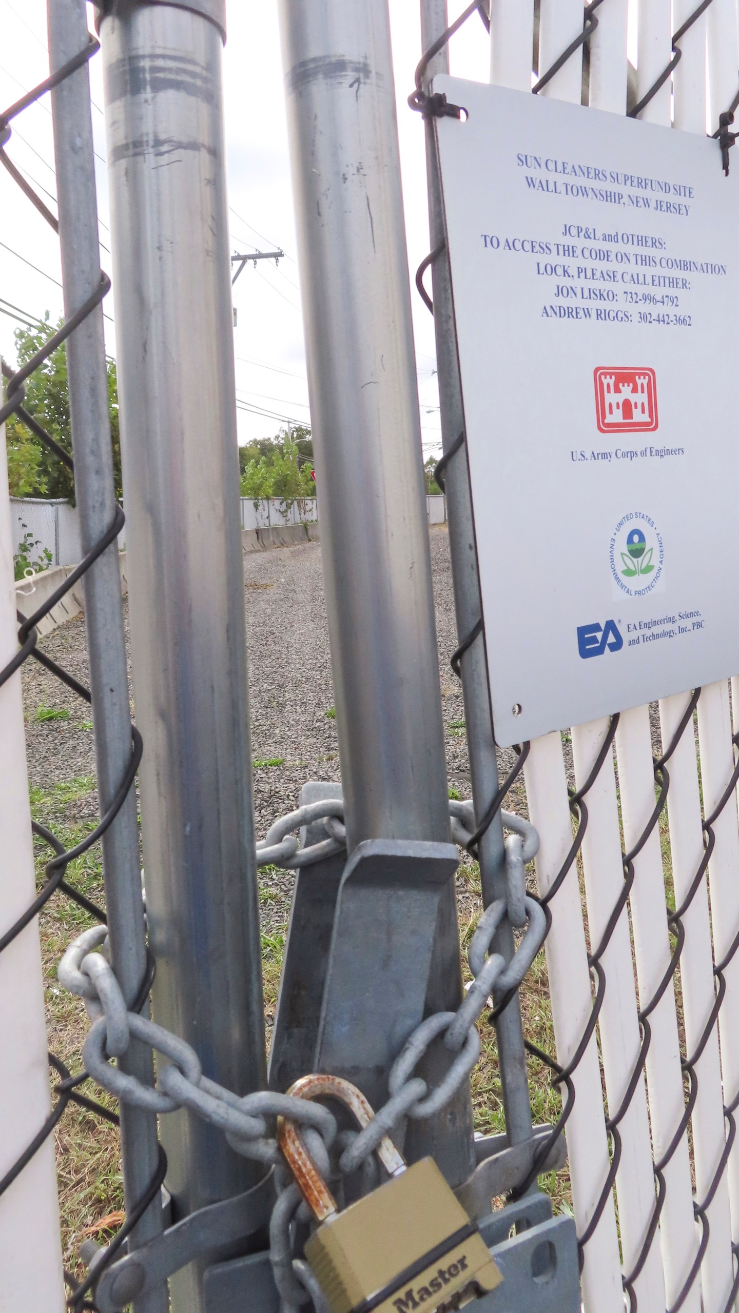 A padlock protects a polluted site in Wall Township, N.J., that could be disturbed by digging for an offshore wind power cable, Sept. 30, 2024. (AP Photo/Wayne Parry)