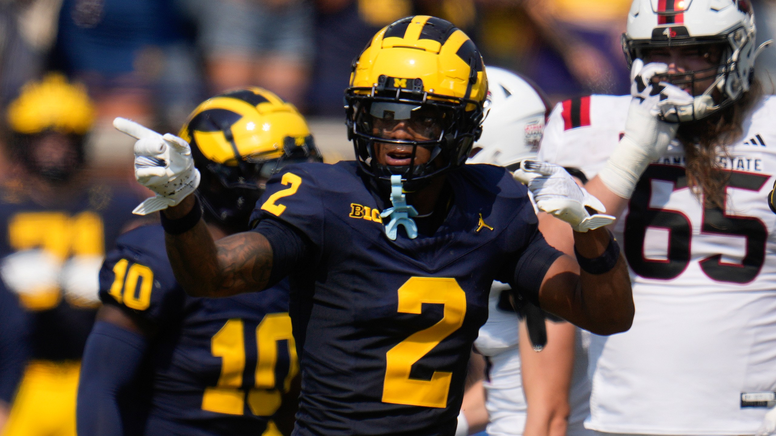 Michigan defensive back Will Johnson (2) celebrates sacking Arkansas State quarterback Jaylen Raynor in the first half of an NCAA college football game in Ann Arbor, Mich., Saturday, Sept. 14, 2024. (AP Photo/Paul Sancya)