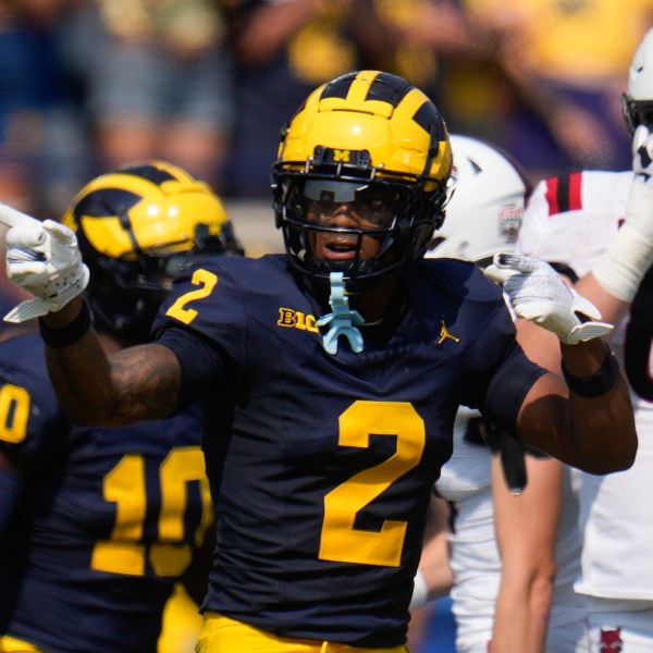 Michigan defensive back Will Johnson (2) celebrates sacking Arkansas State quarterback Jaylen Raynor in the first half of an NCAA college football game in Ann Arbor, Mich., Saturday, Sept. 14, 2024. (AP Photo/Paul Sancya)