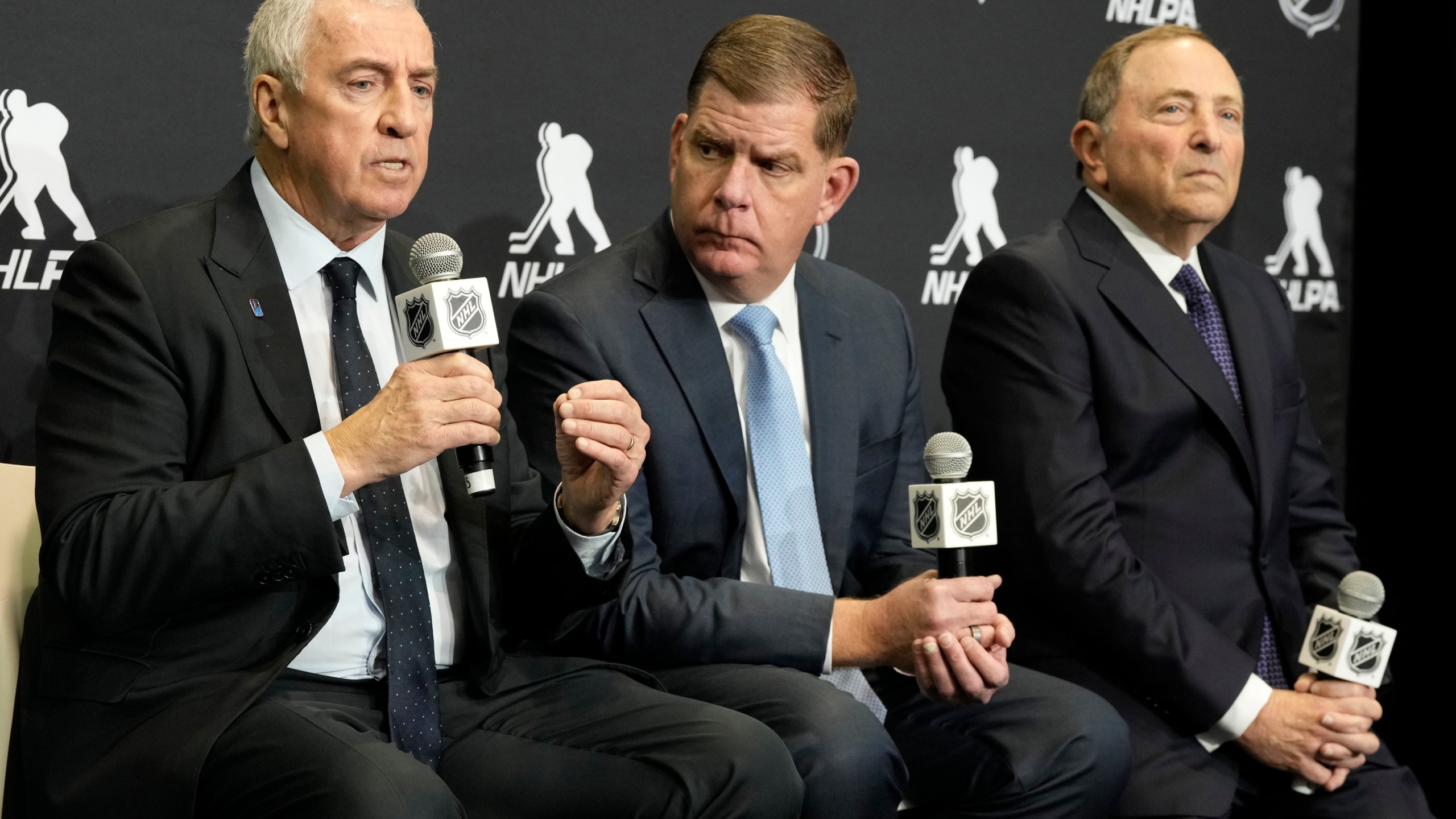 FILE - IIHF president Luc Tardif, left to right, NHLPA Executive Director Marty Walsh and NHL Commissioner Gary Bettman attend a news conference in Toronto, Feb. 2, 2024. (Frank Gunn/The Canadian Press via AP, File)